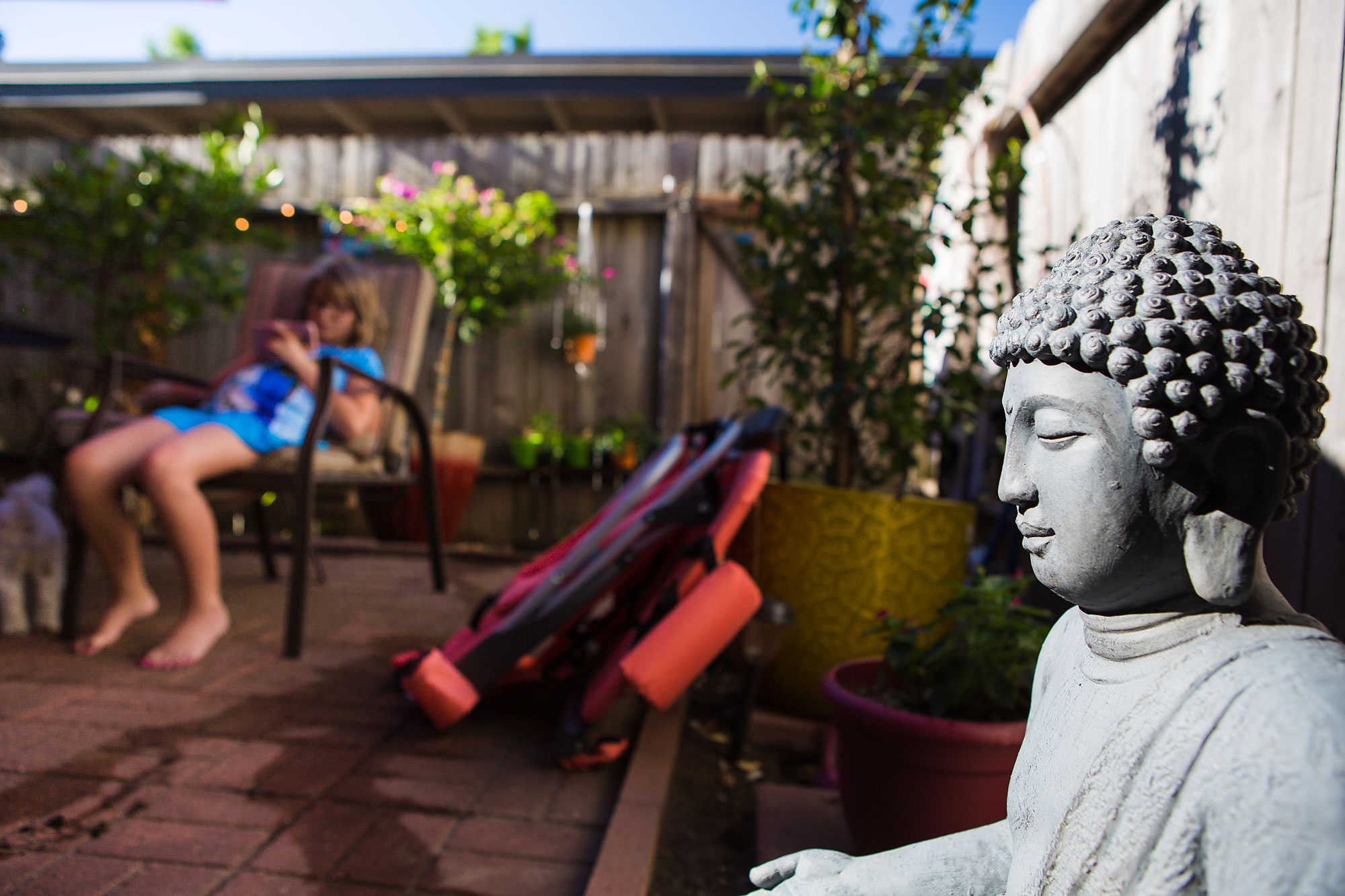 buddha statue in backyard - documentary family photography