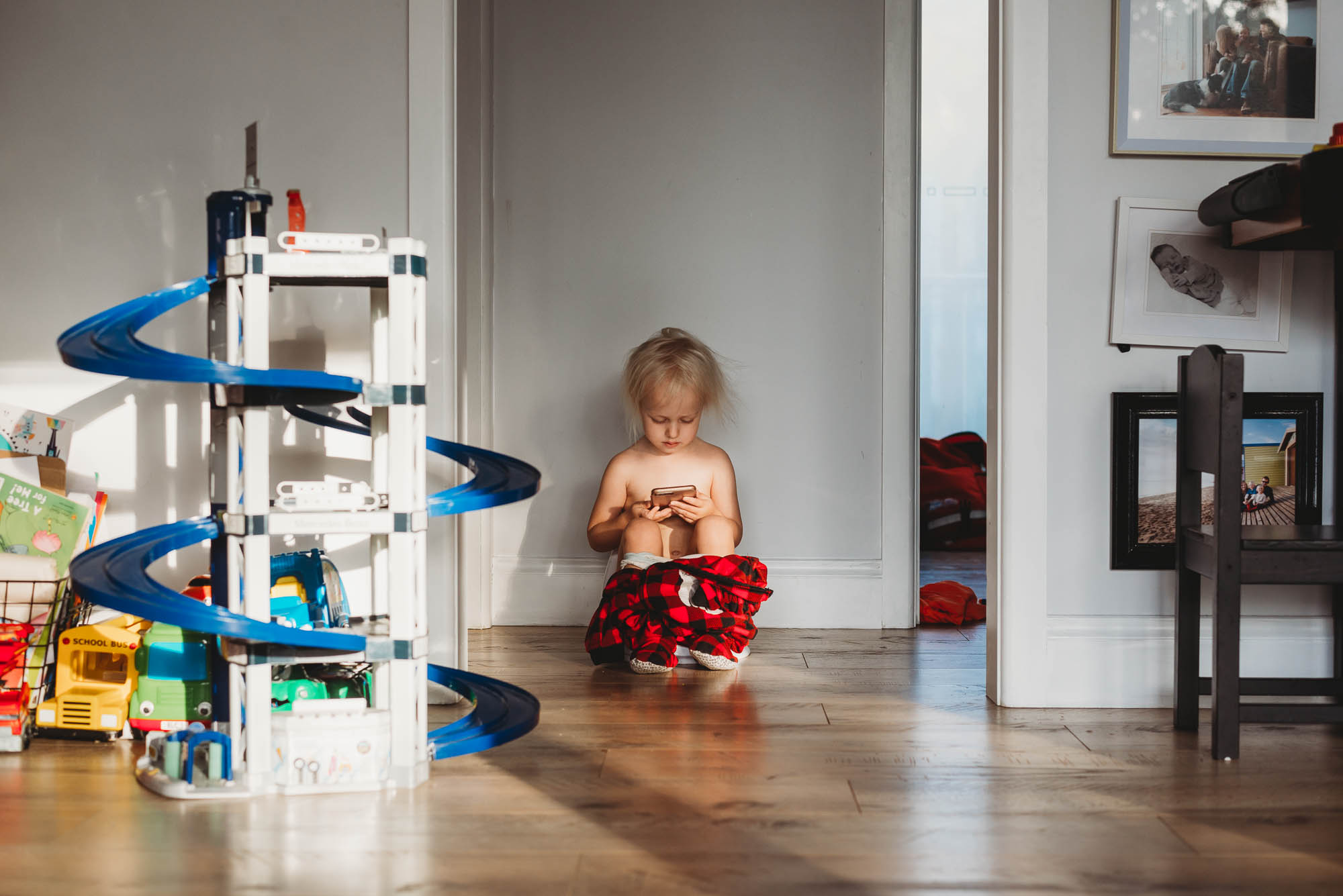 girl plays alone in hallway - documentary family photography