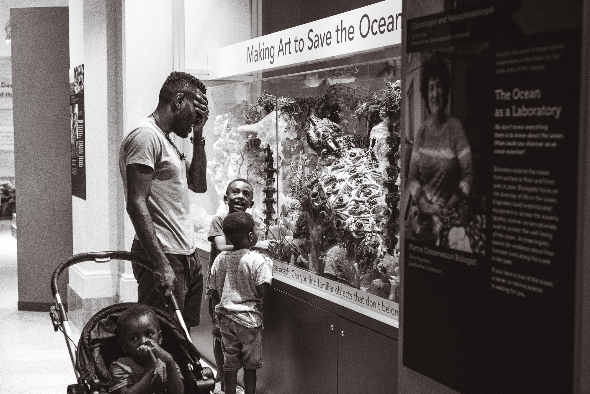 father with kids outside ocean display - documentary family photography