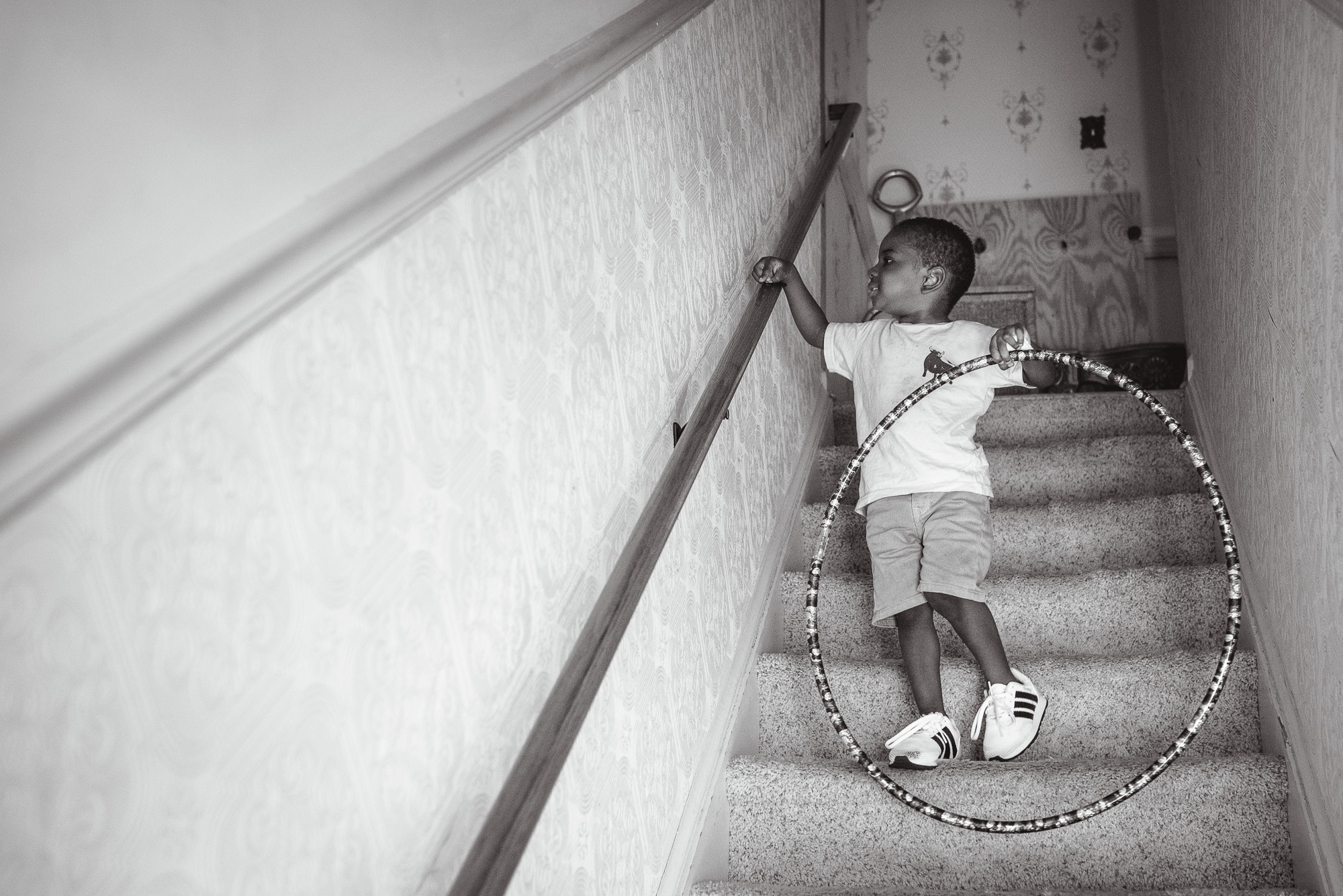 boy with hula hoop on stairs - documentary family photography