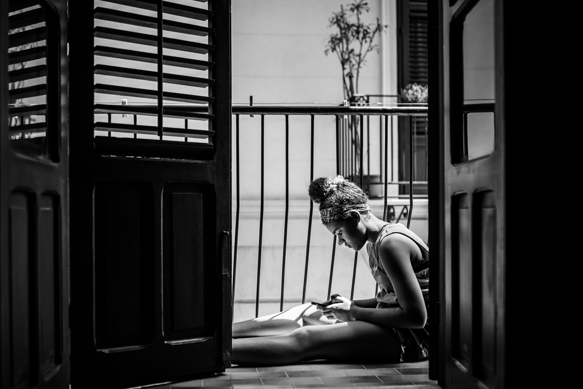 girl sitting on balcony - documentary family photography