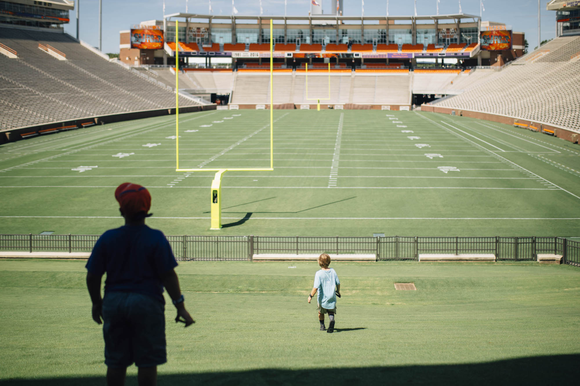 kid on football field - documentary family photography