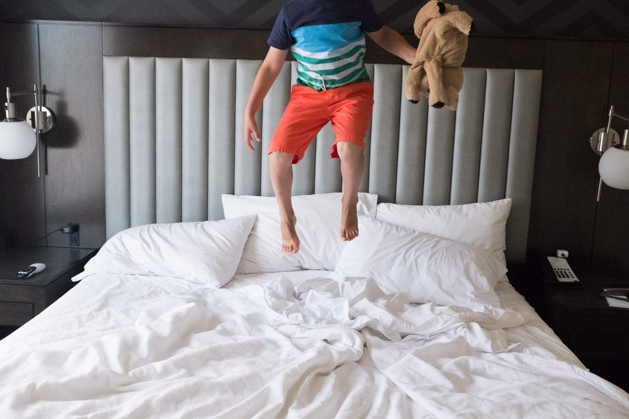 kid jumping on bed - documentary family photography