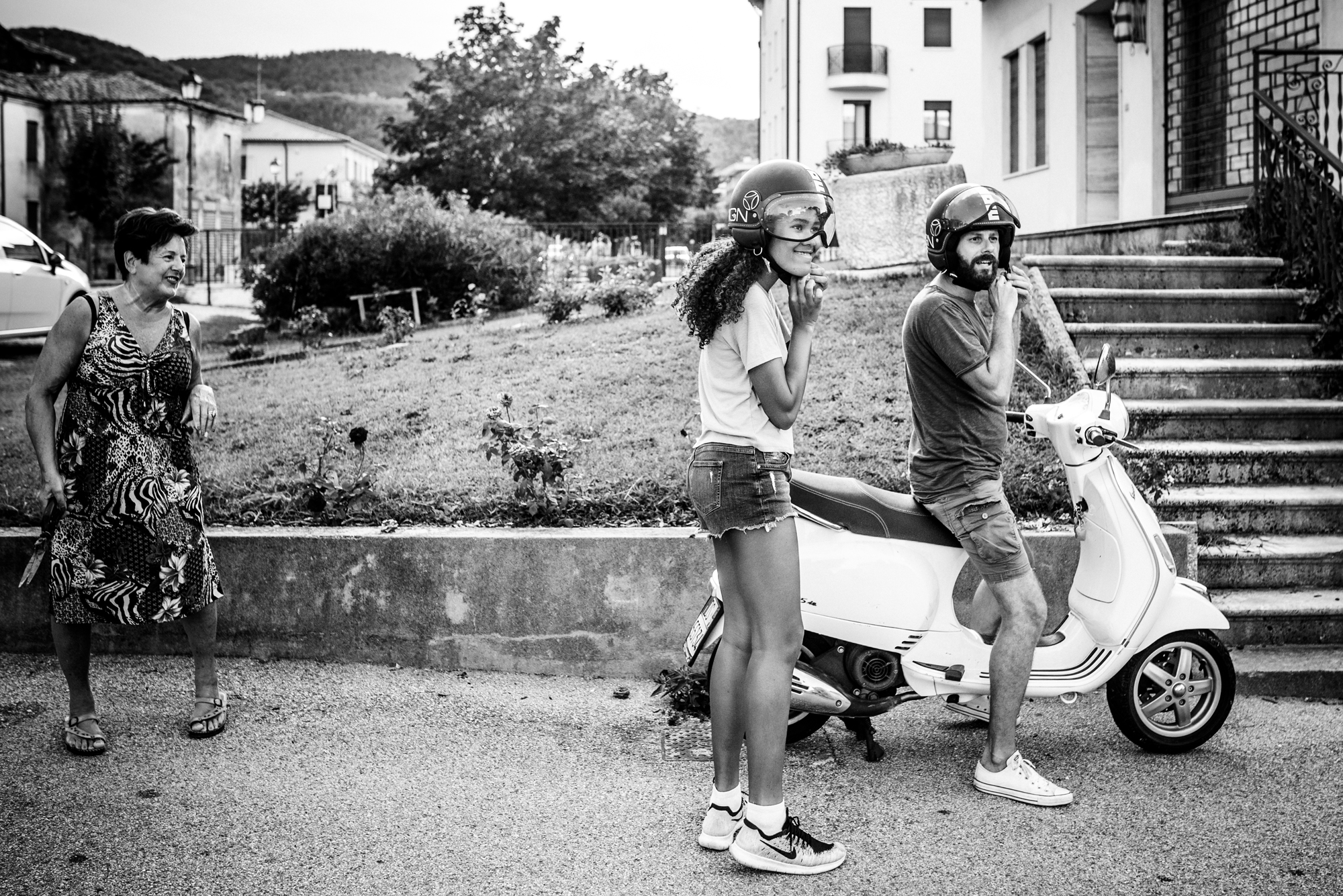 man and girl putting on helmets for scooter - documentary family photography