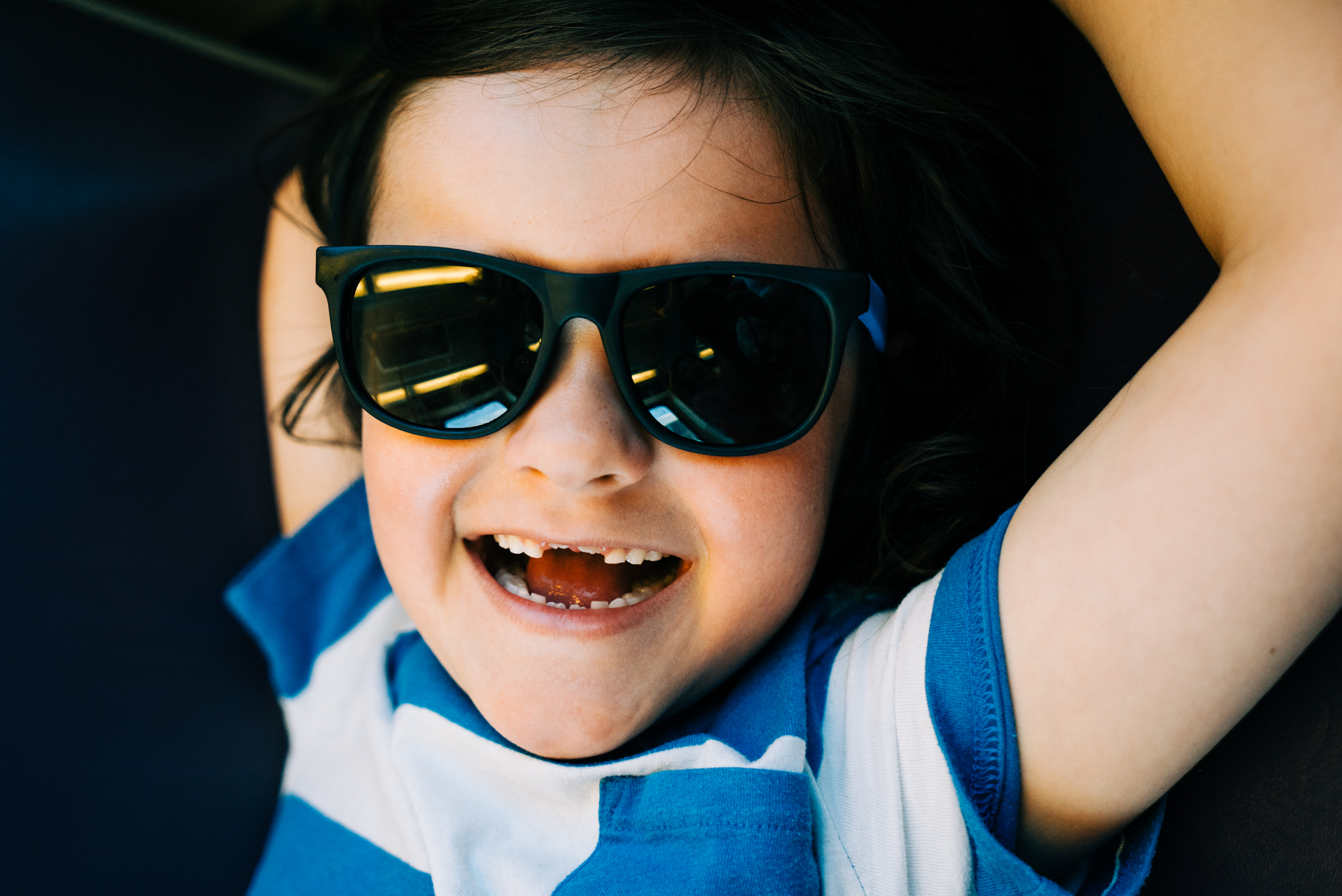 child with sunglasses on - documentary family photography