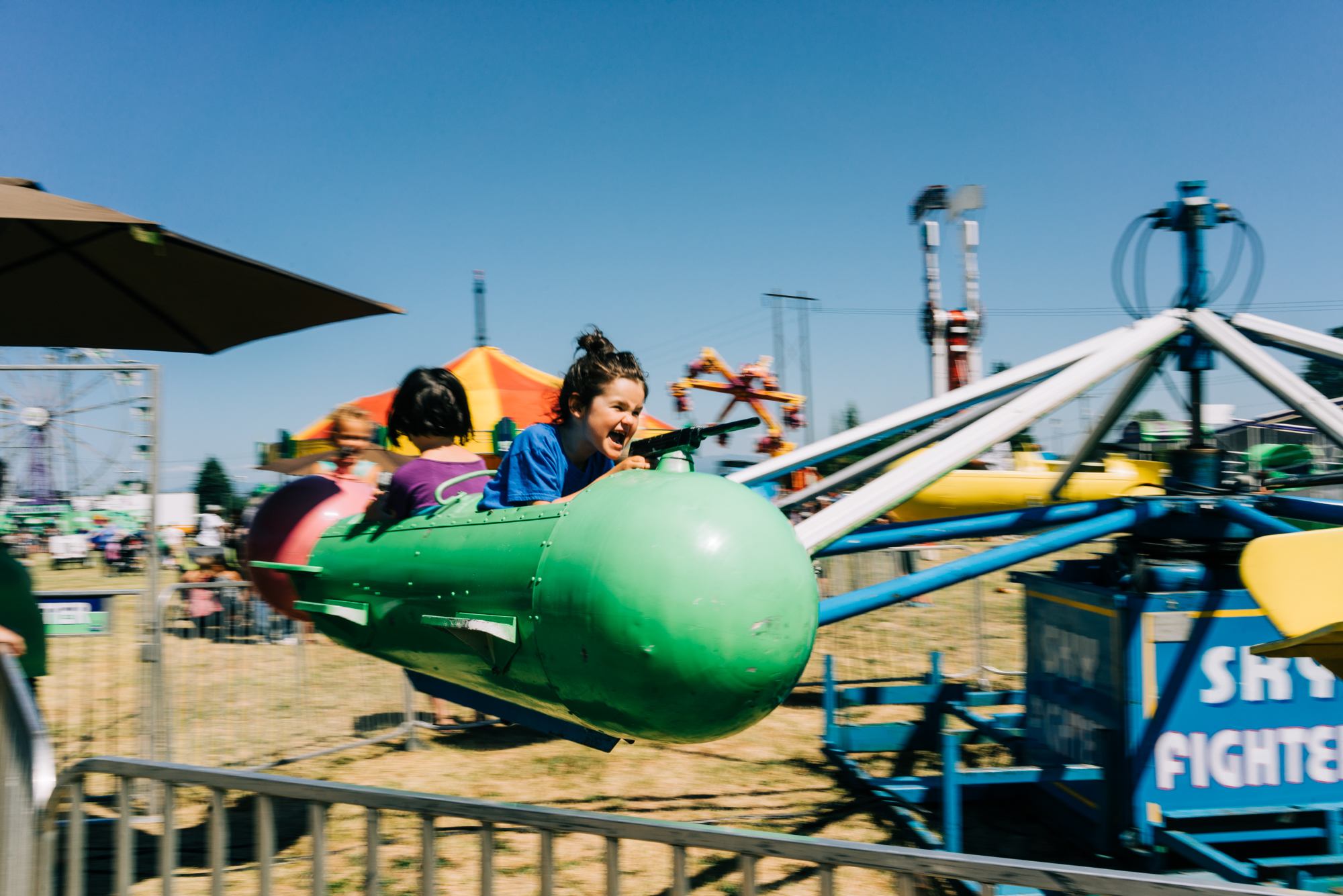 boy on carnival ride - documentary family photography