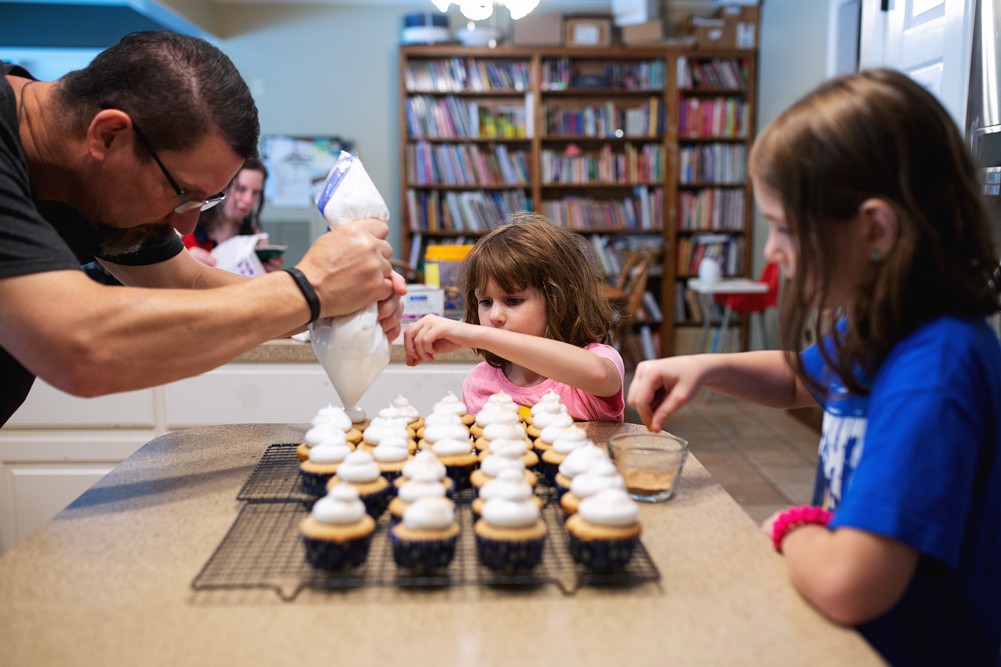 family decorates cupcakes - documentary family photography