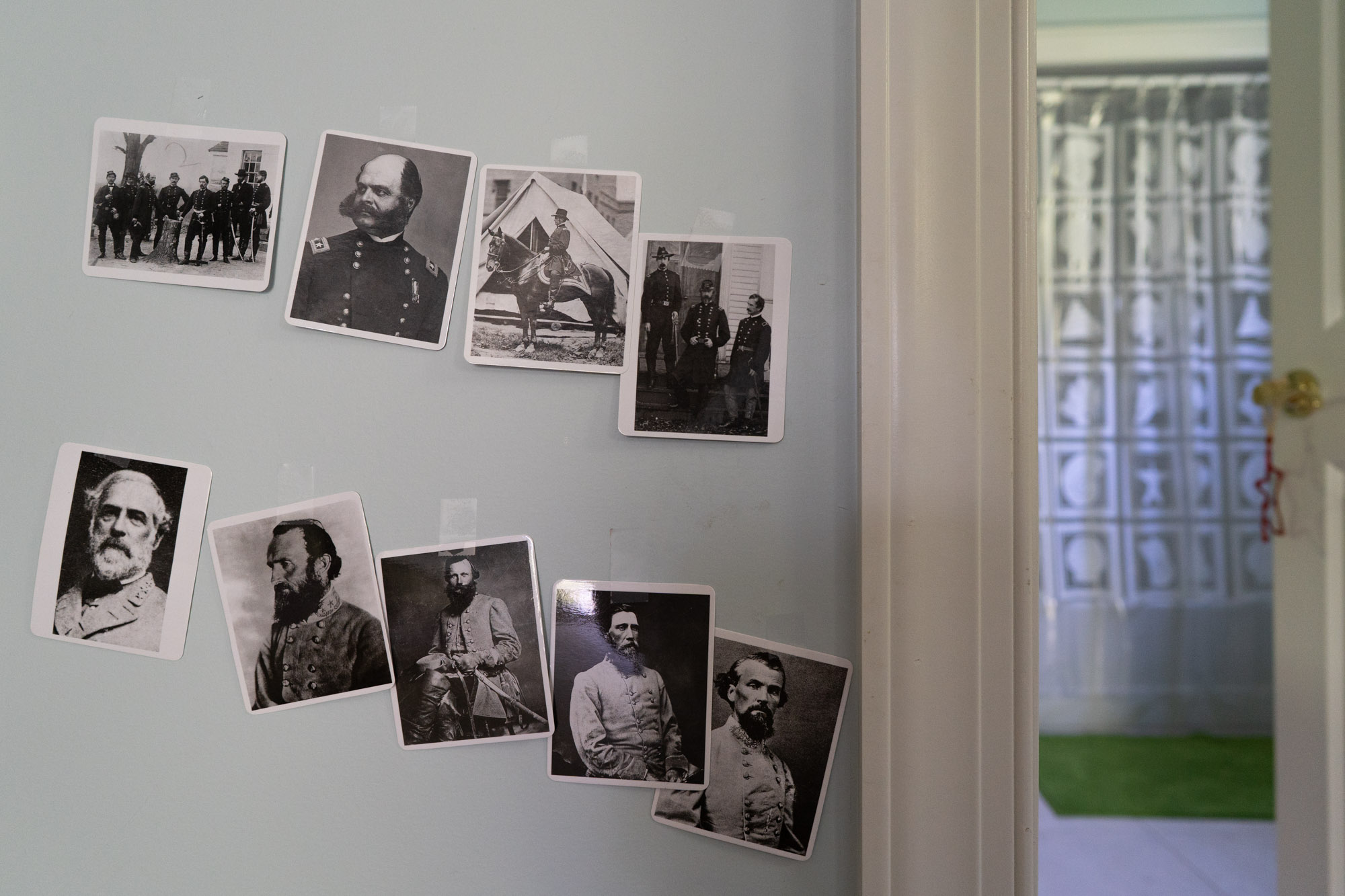 historic photos taped on wall - documentary family photography