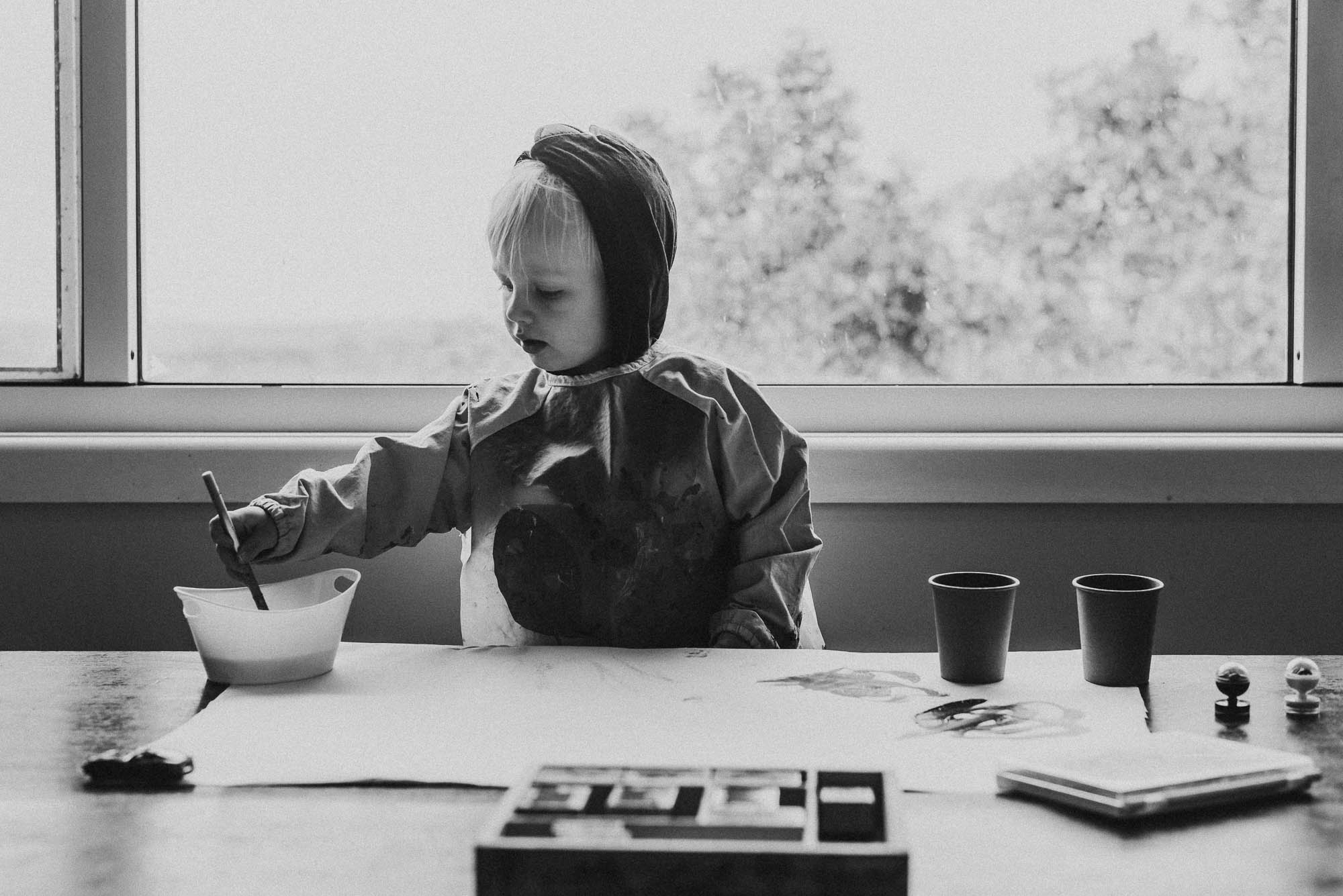 child painting at table - documentary family photography