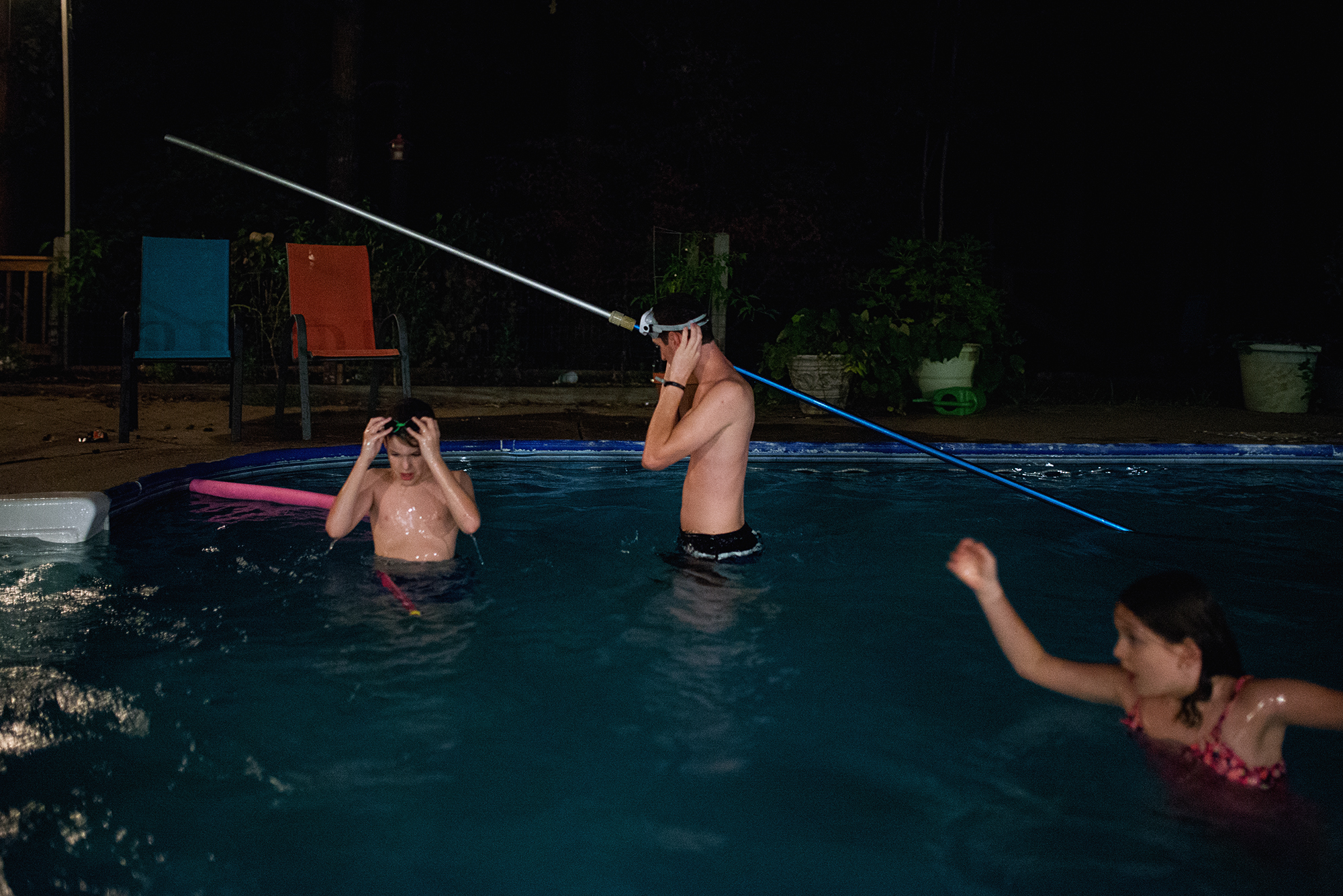kids in pool at night - documentary family photography