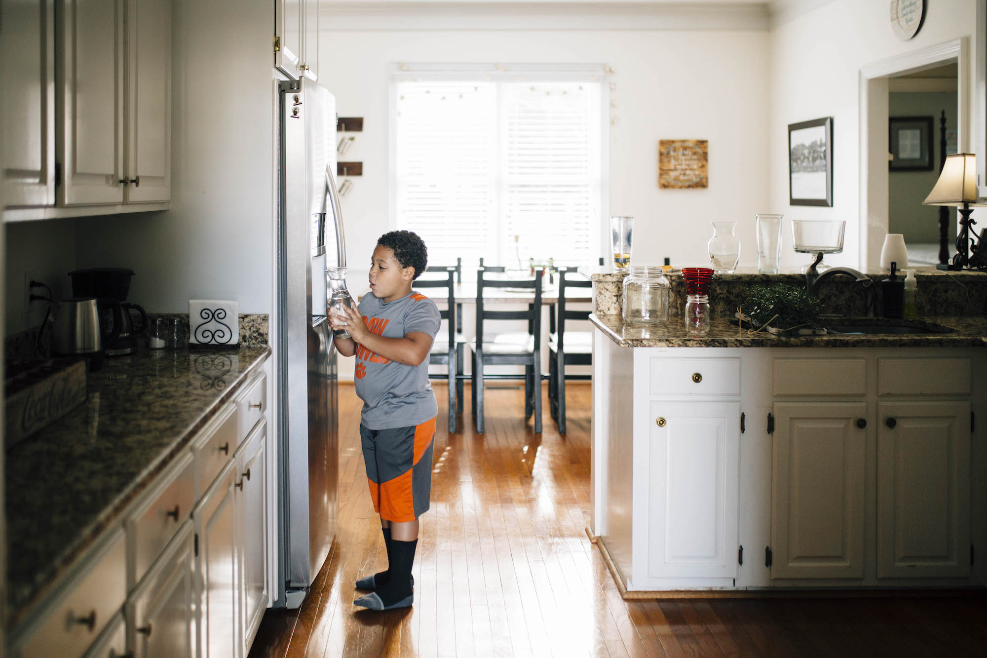 boy at fridge - documentary family photography