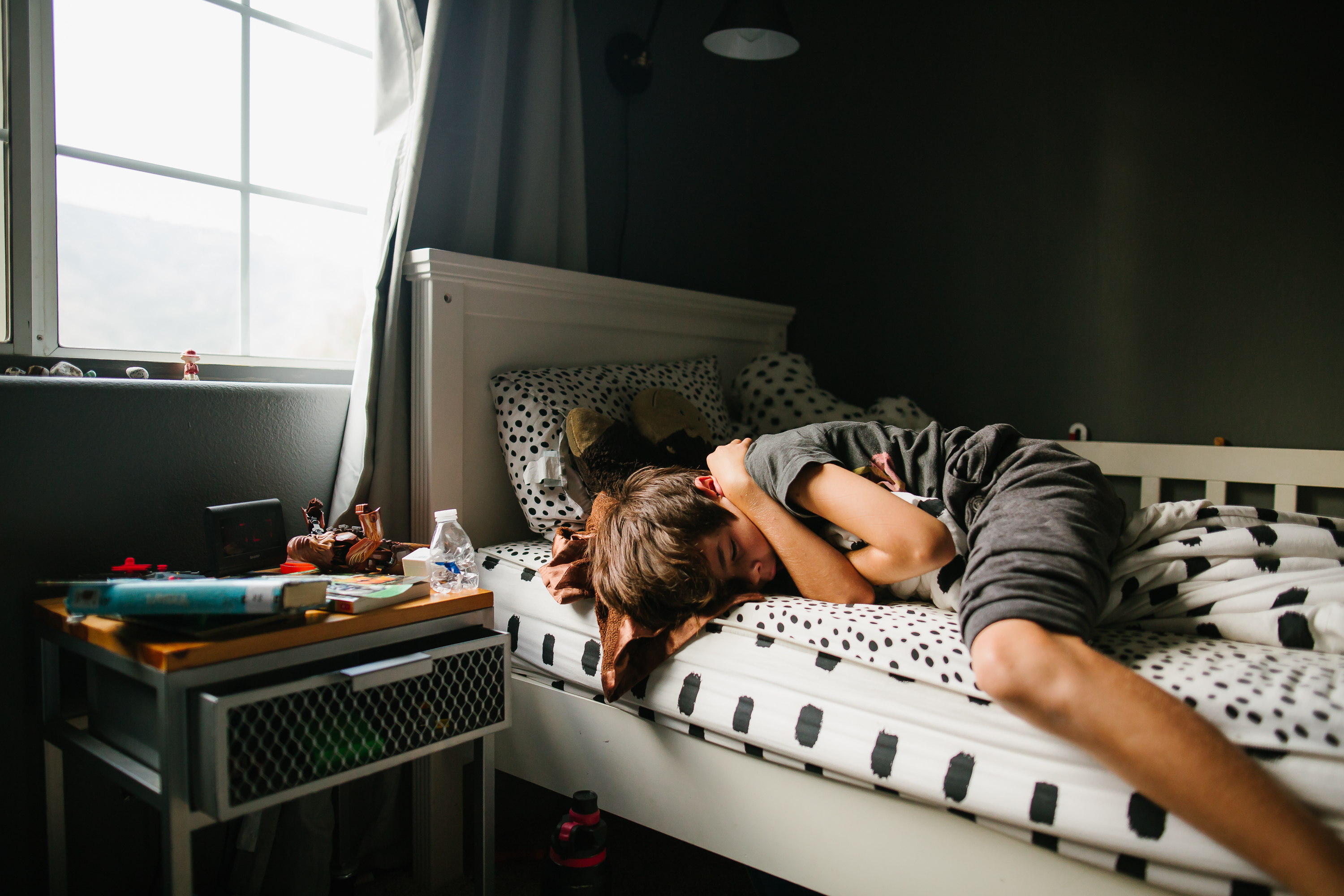 kids wrestle on bed - documentary family photography