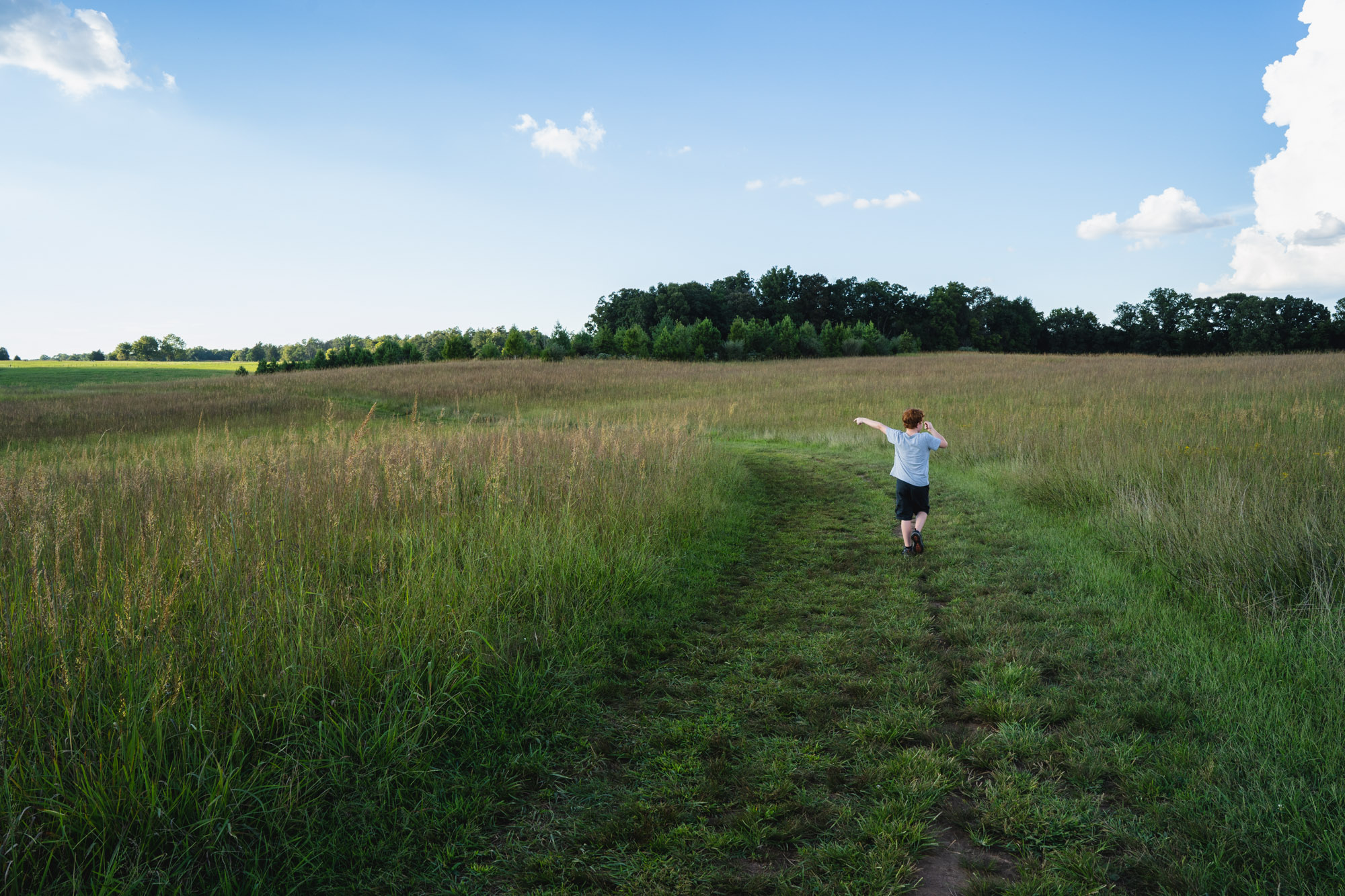 boy in field- documentary family photography