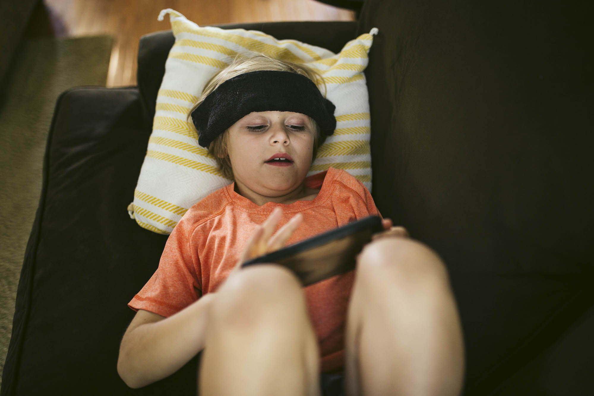 sick child on phone - documentary family photography