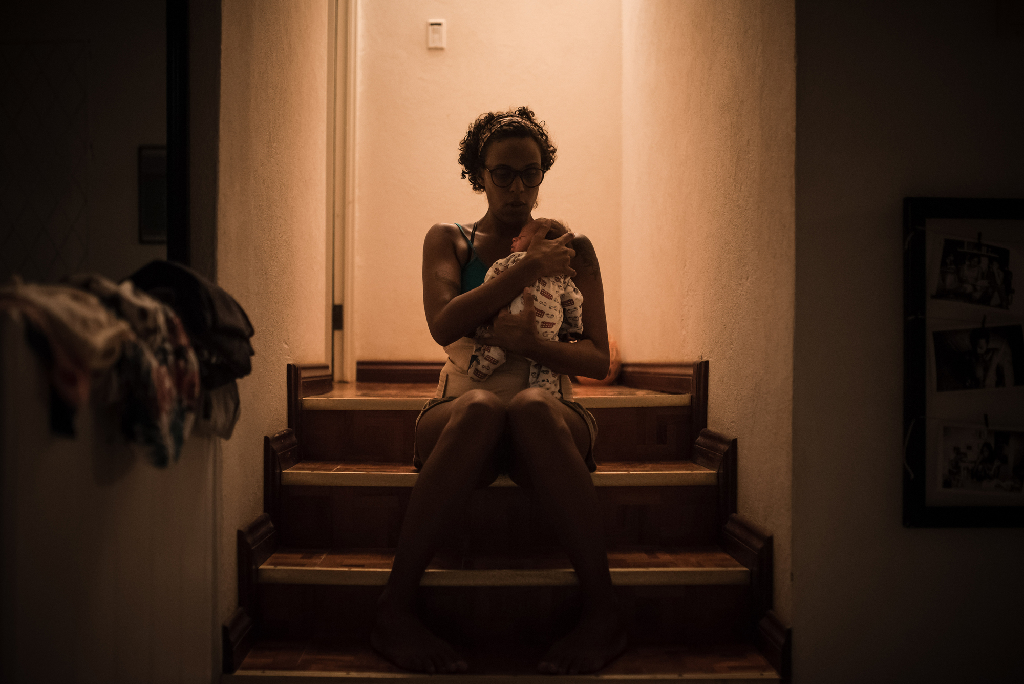 woman with newborn on stairs - documentary family photography