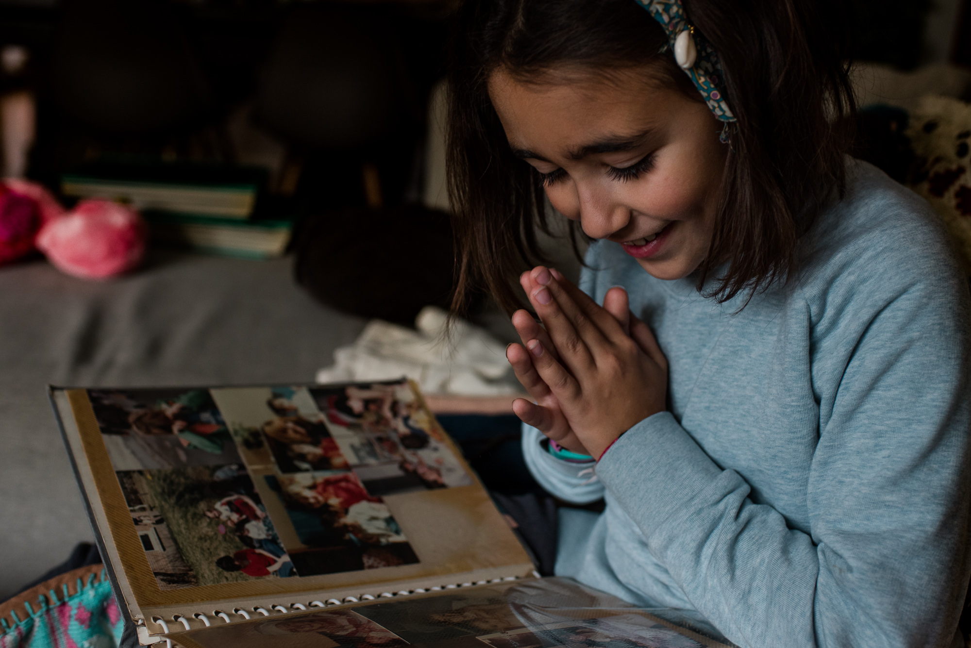 girl looking at scrapbook - documentary family photography