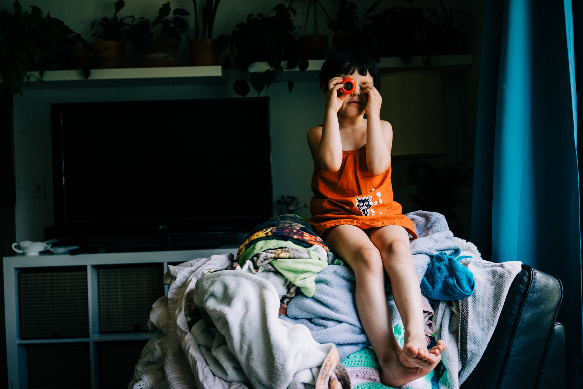 girl tries on sunglasses - documentary family photography