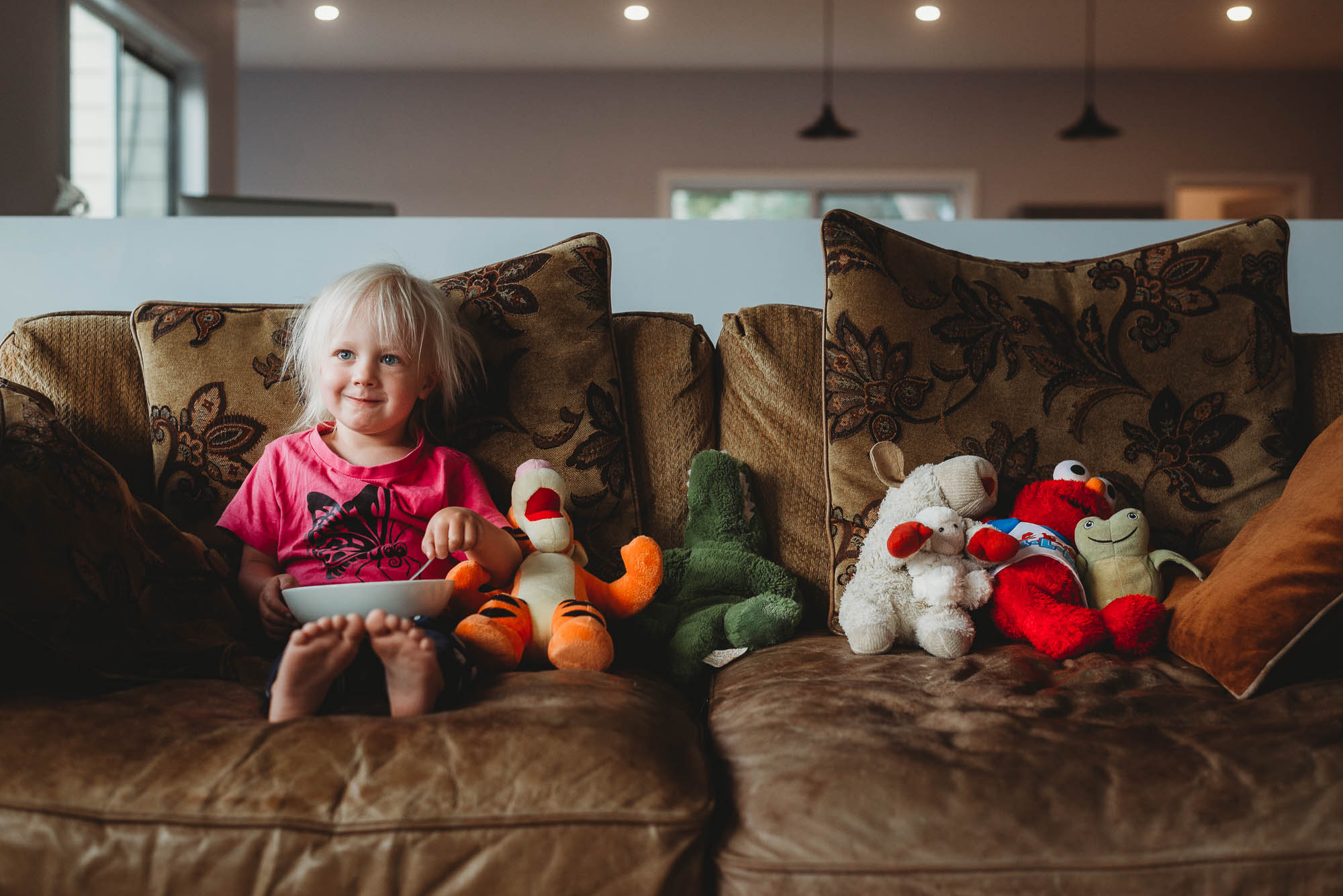 girl on couch with animal friends - documentary family photography