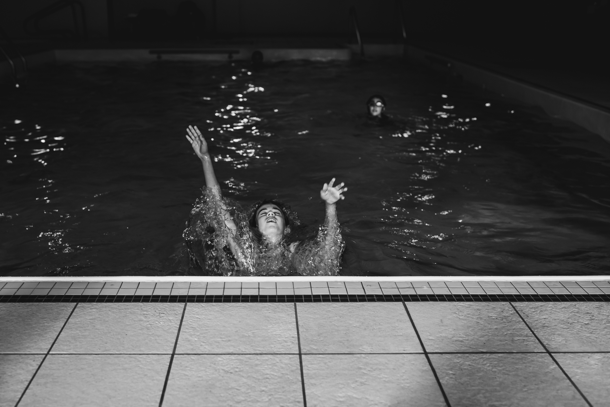 girl erupts from pool -documentary family photography