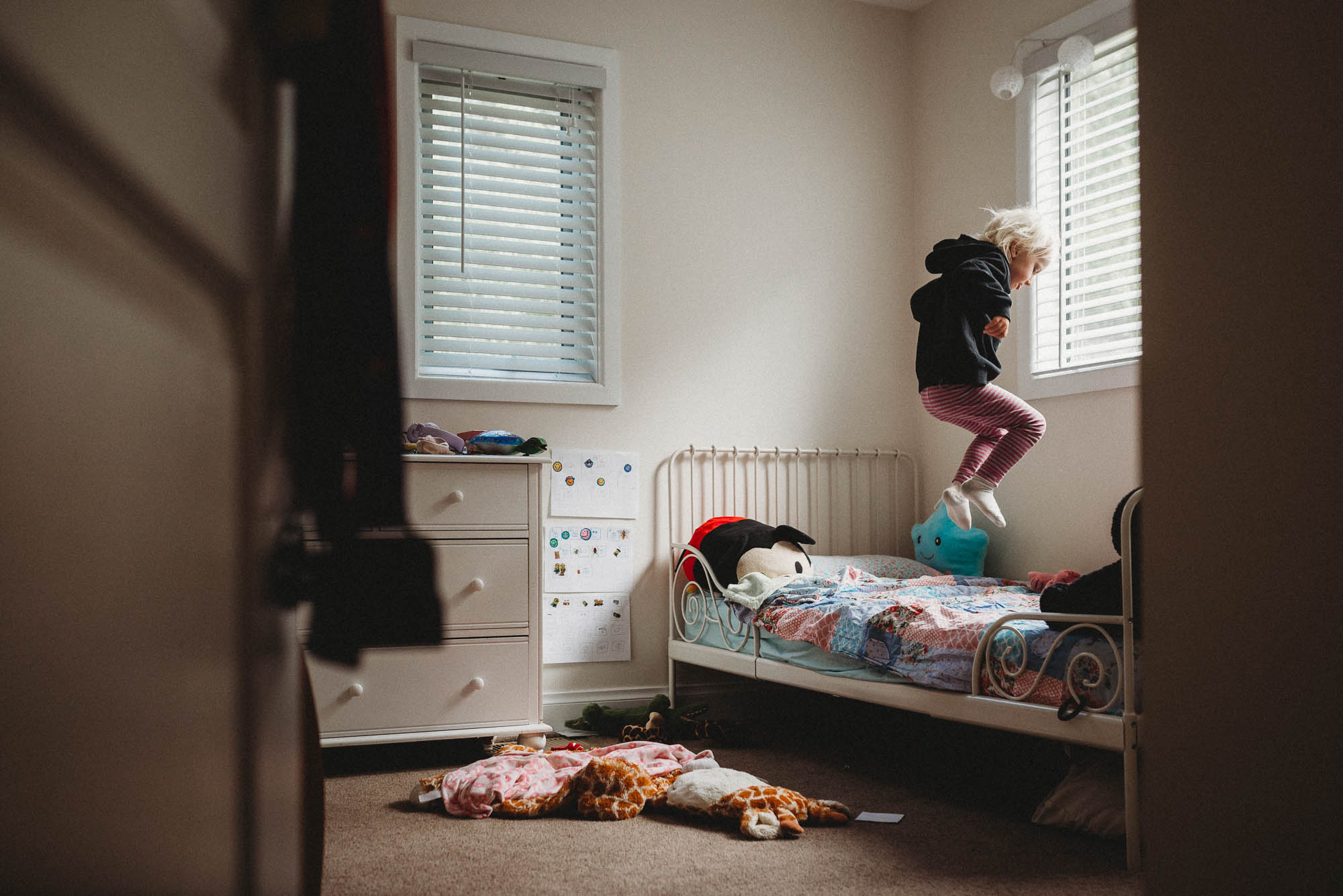 kid jumping on bed - documentary family photography