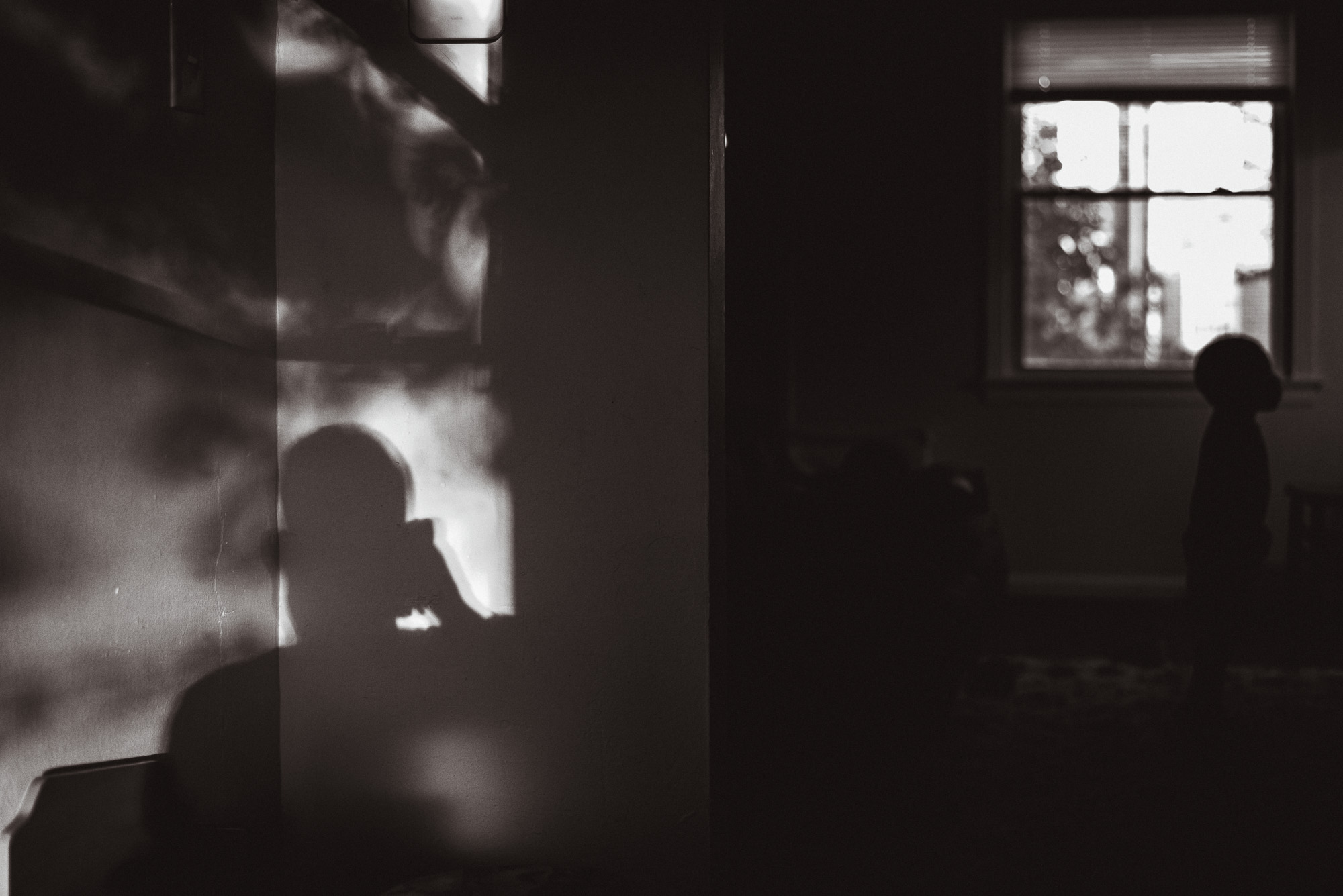 boy's shadow on wall - documentary family photography