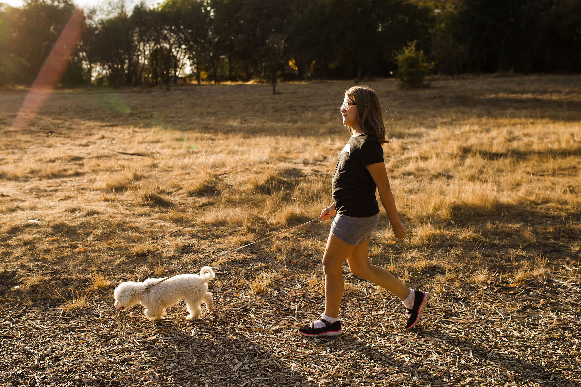 girl walking dog - documentary family photography
