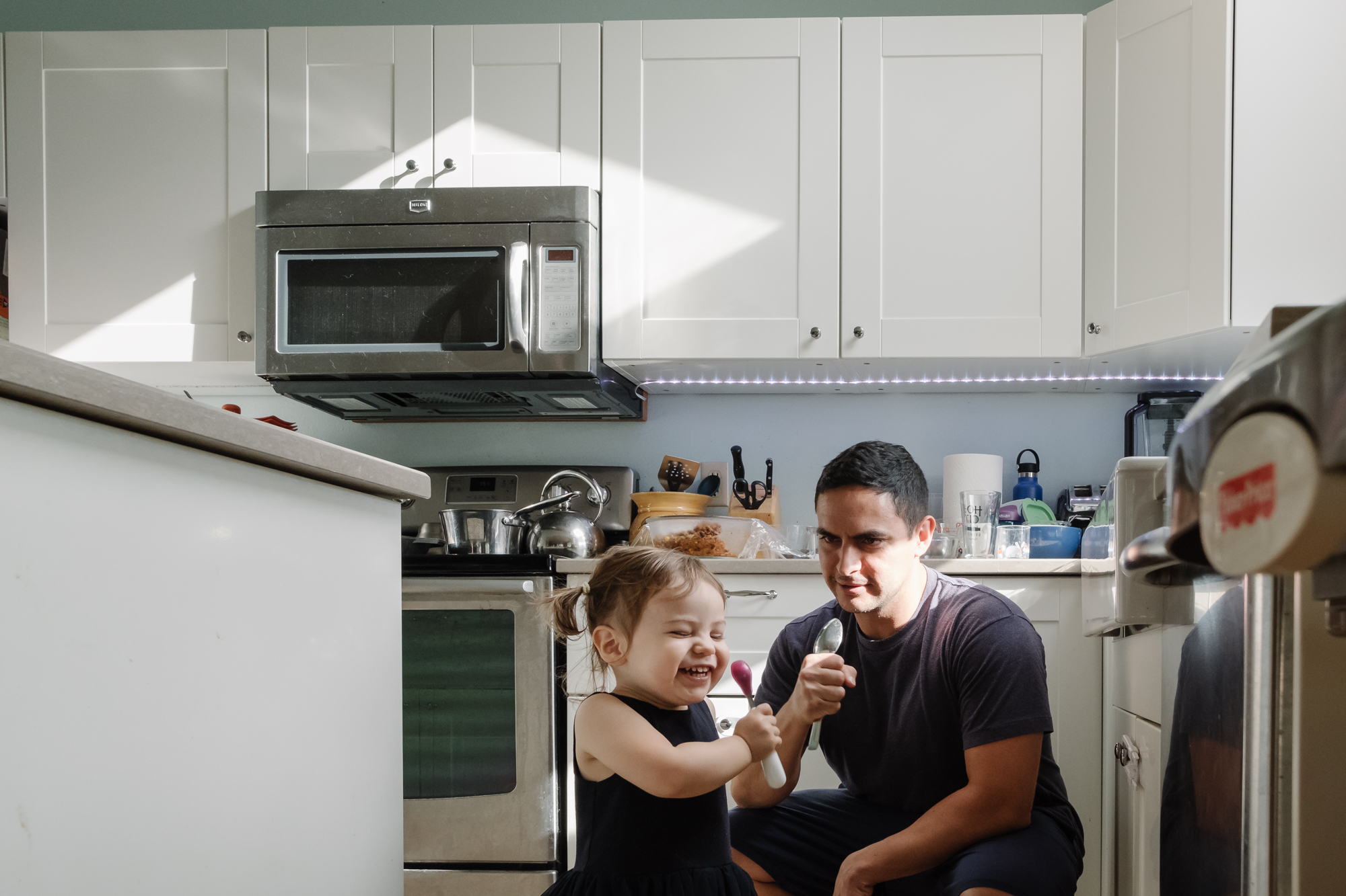 father and daughter sing into spoons - documentary family photography