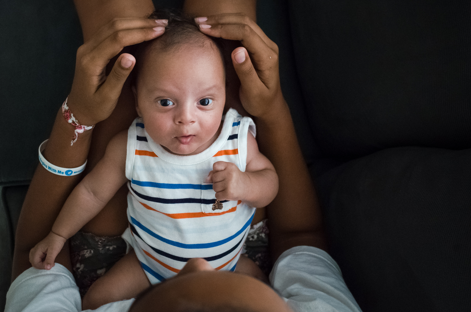 baby looking at camera - documentary family photography