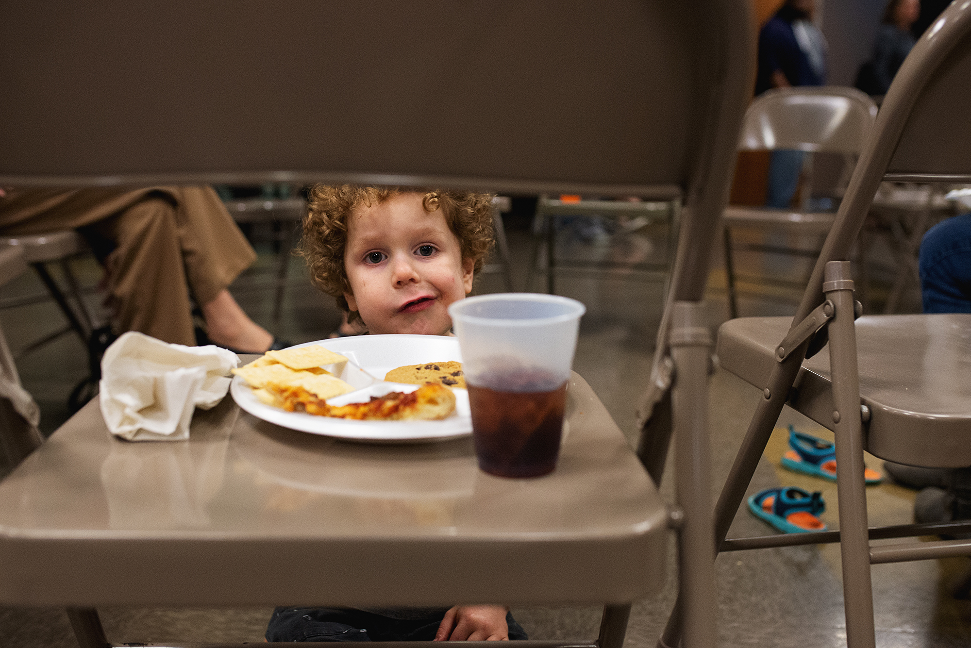 boy makes face during meal - documentary family photography