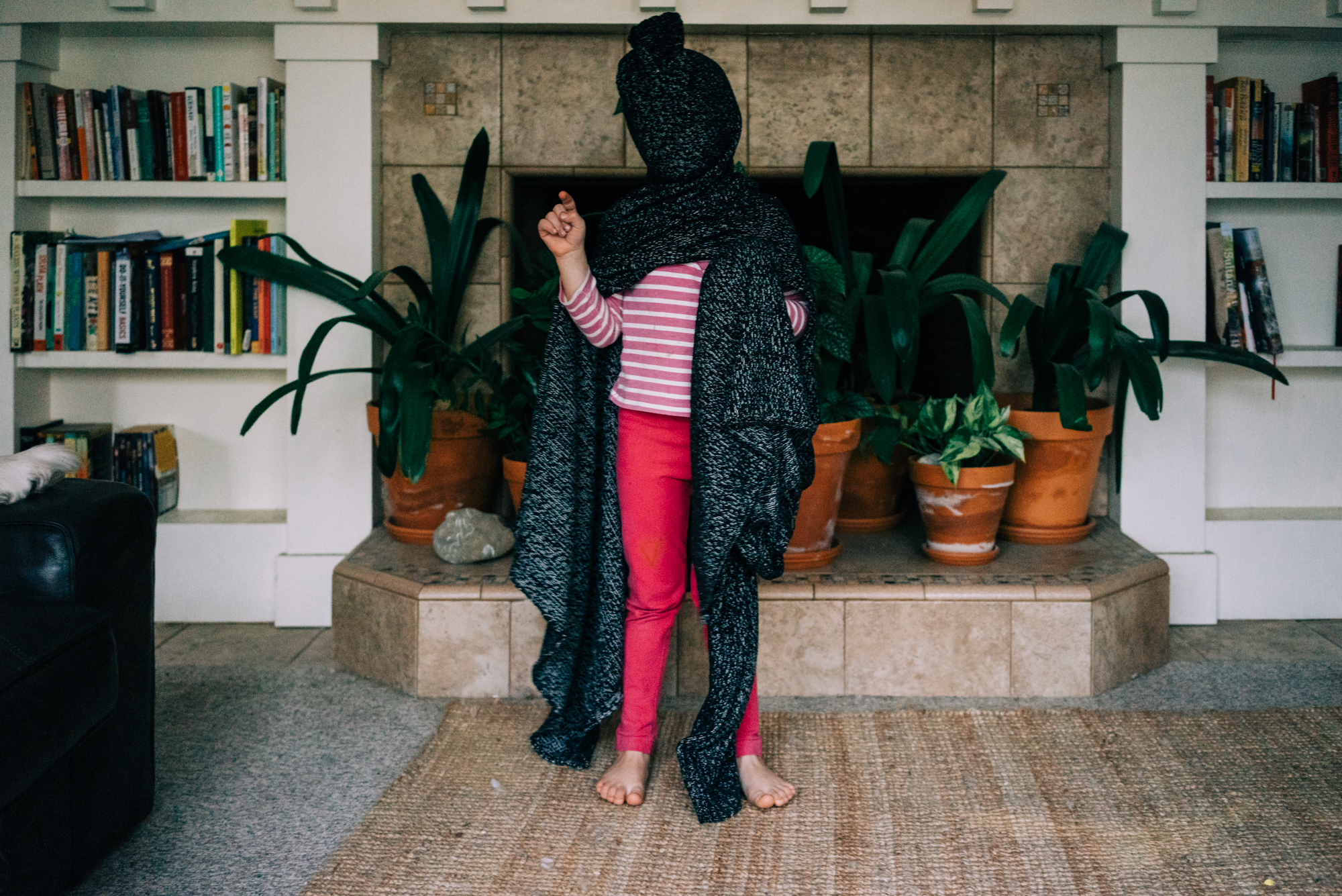 girl with sweater wrapped around head - documentary family photography