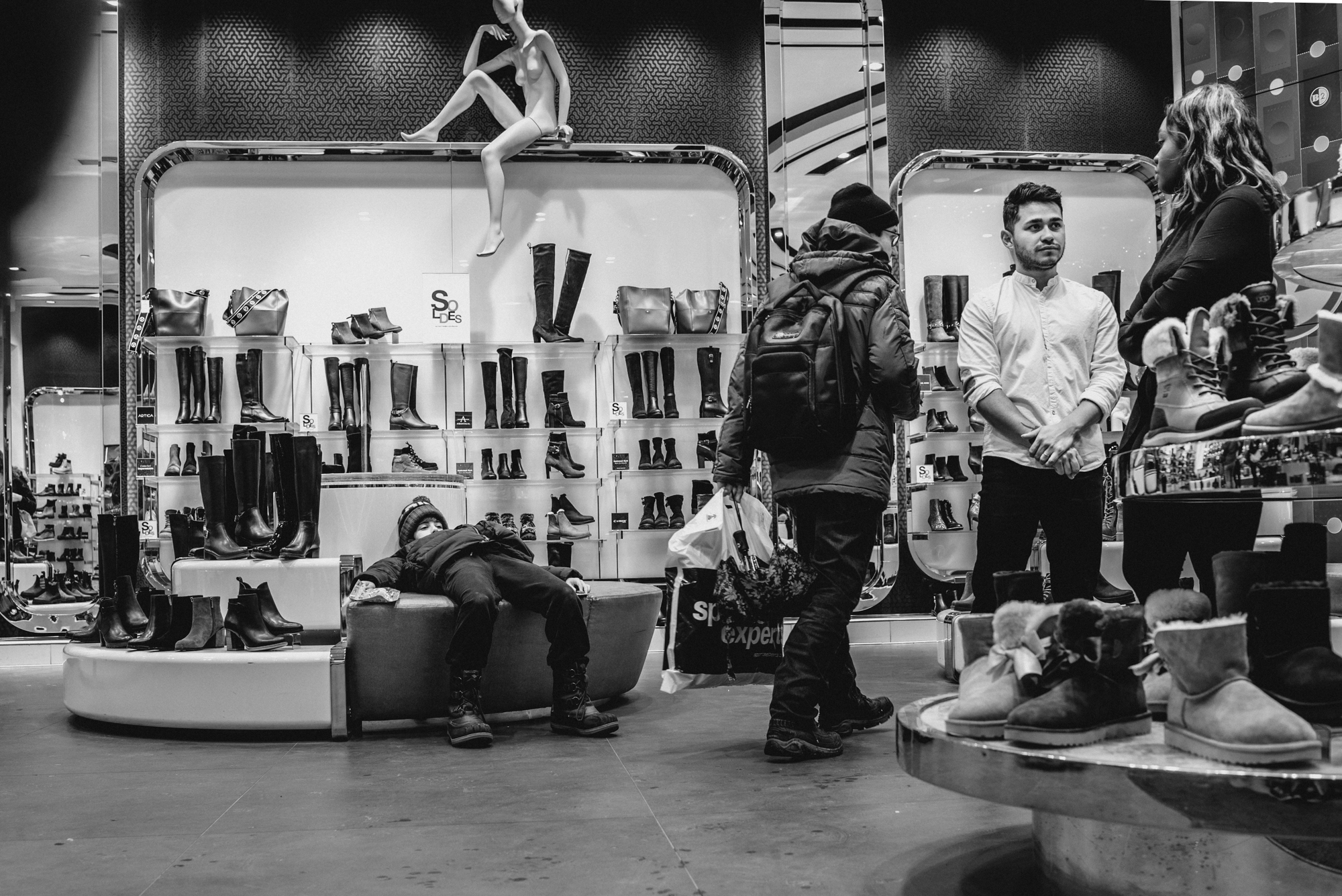 kid slumps in chair at shoes store - documentary family photography