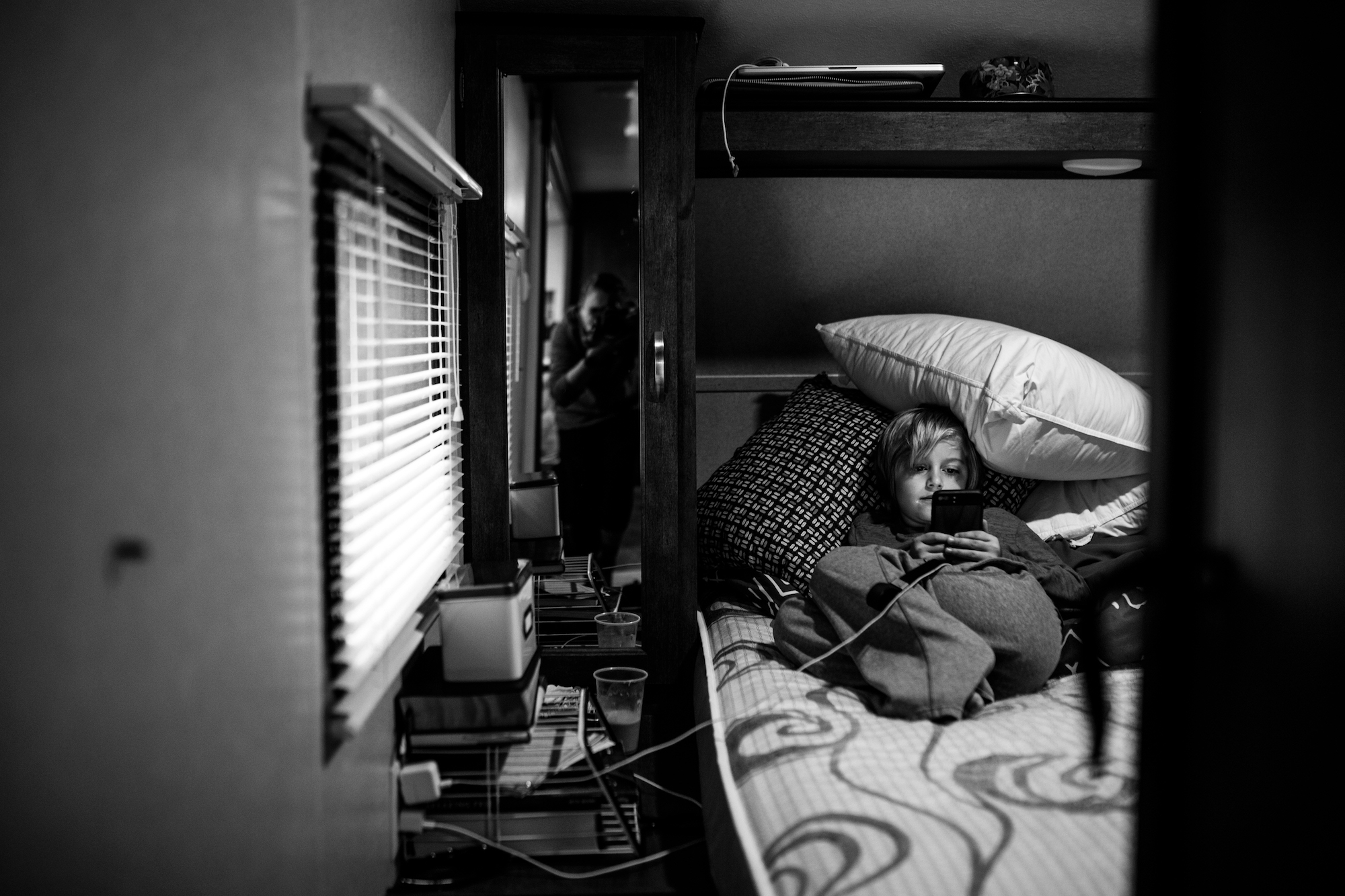 boy wrapped in bedding - documentary family photography