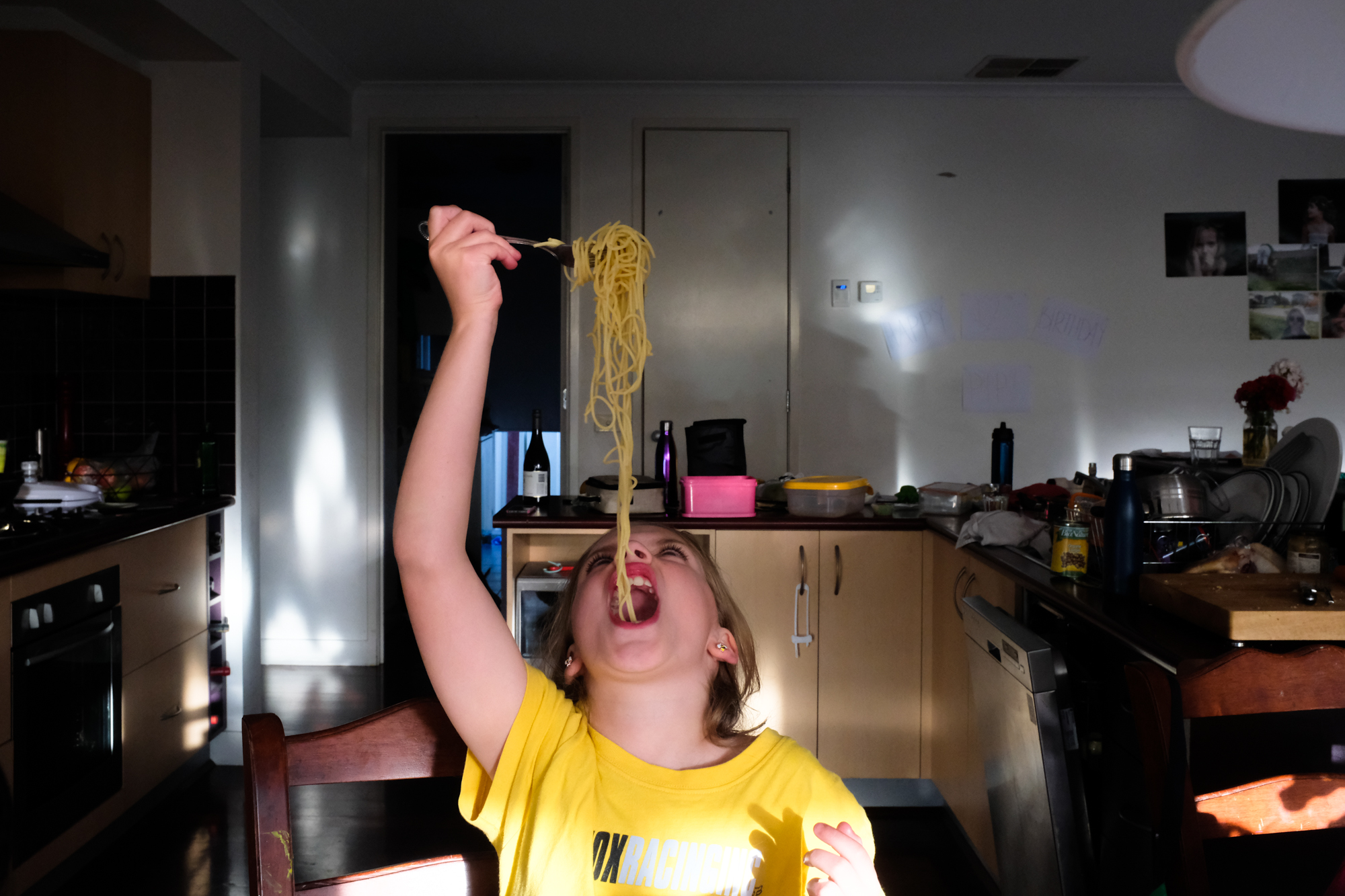 girl eating pasta - documentary family photography