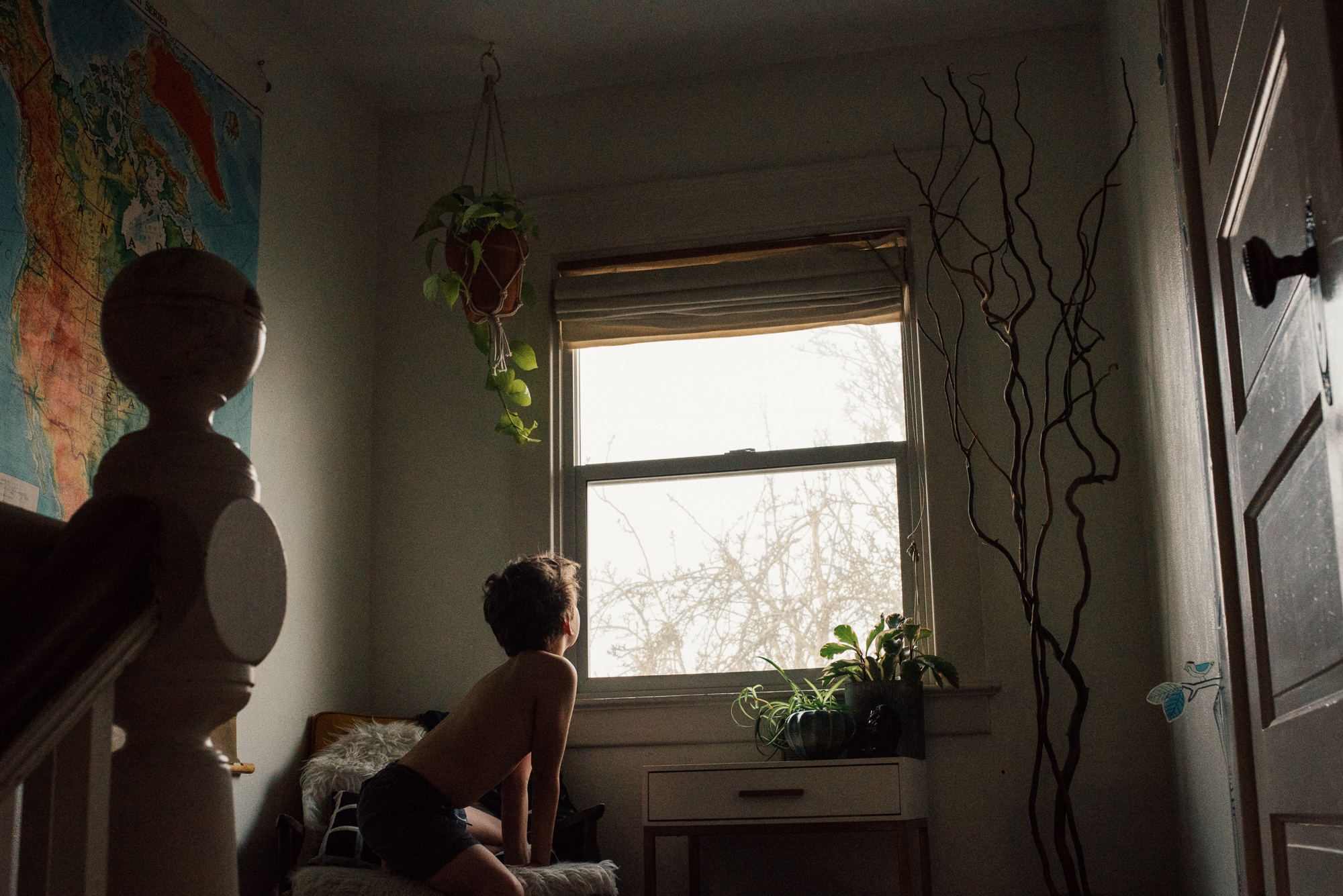 boy looking out window - documentary family photography