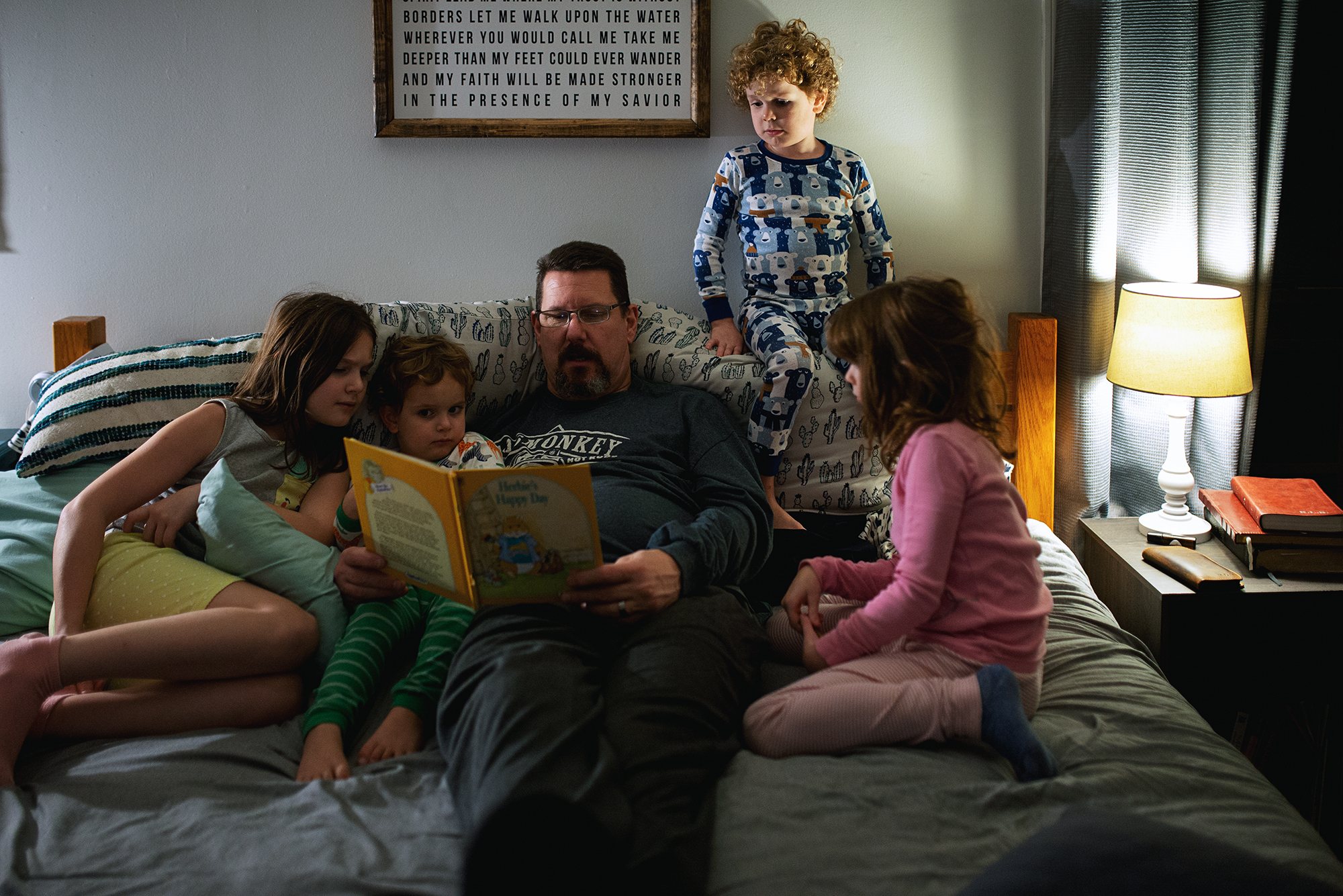 kids listening to father read book - documentary family photography