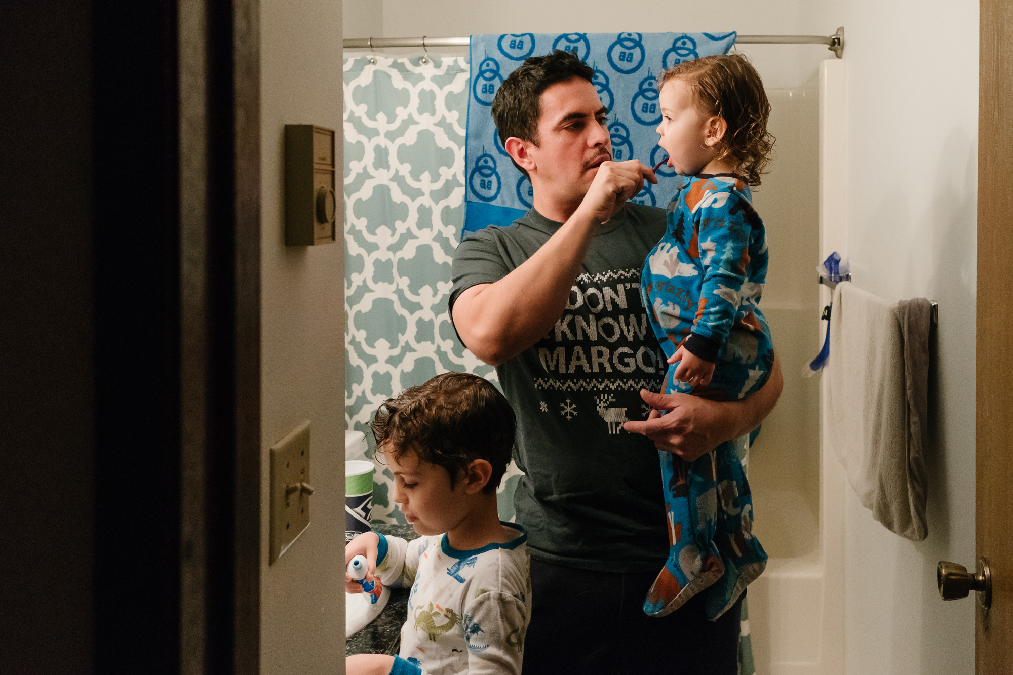 father helping kids brush teeth - documentary family photography