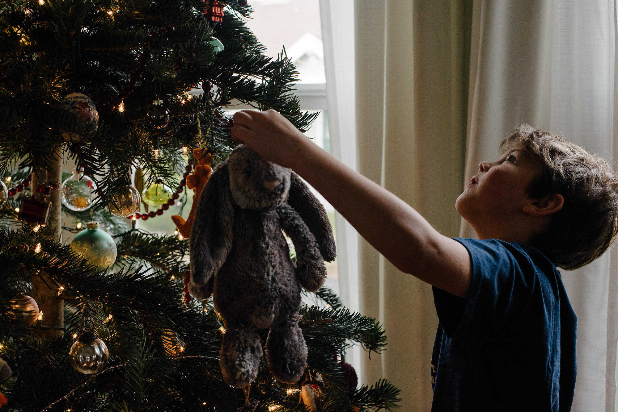 child at Christmas tree - documentary family photography