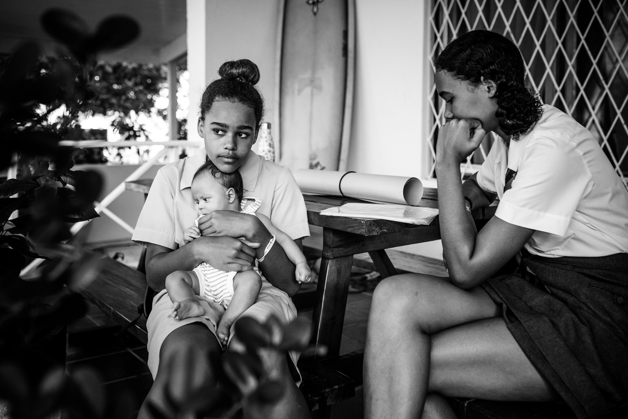 girl holding baby - documentary family photography
