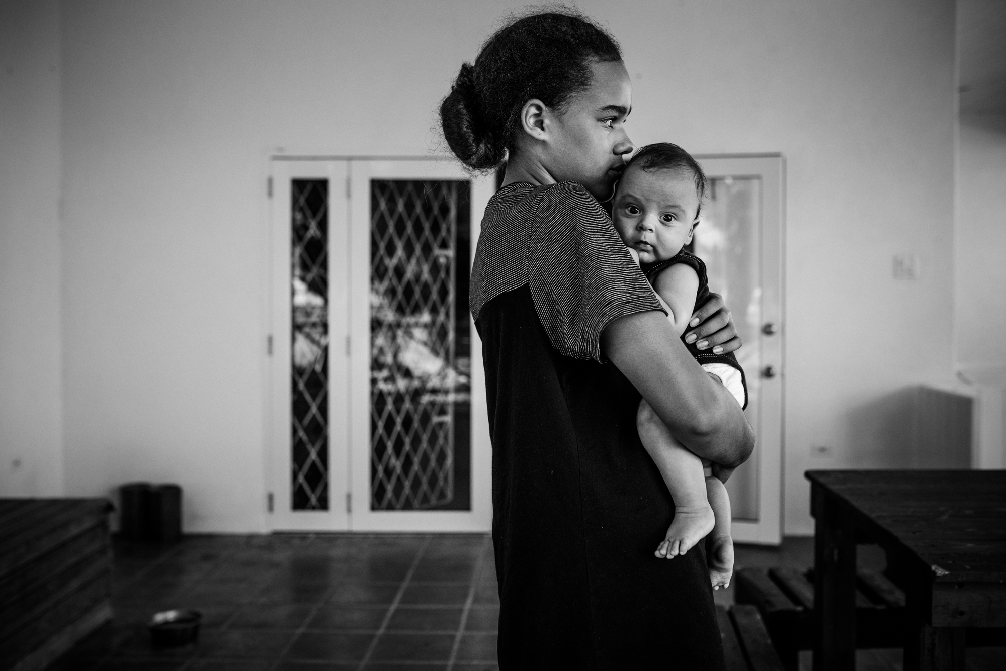 sister hold baby - documentary family photography