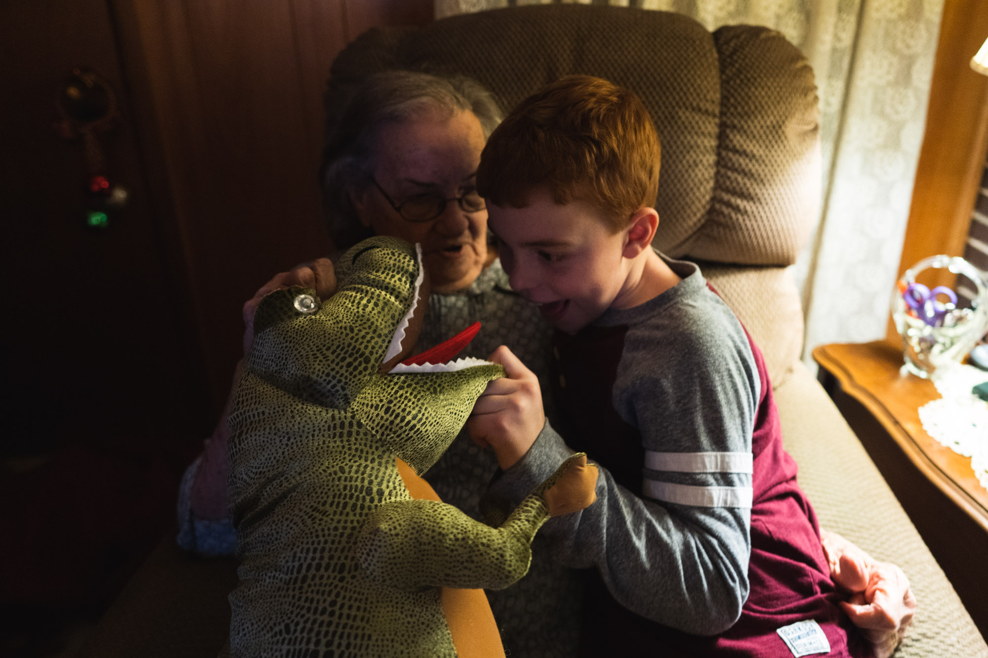boy with dino puppet - documentary family photography