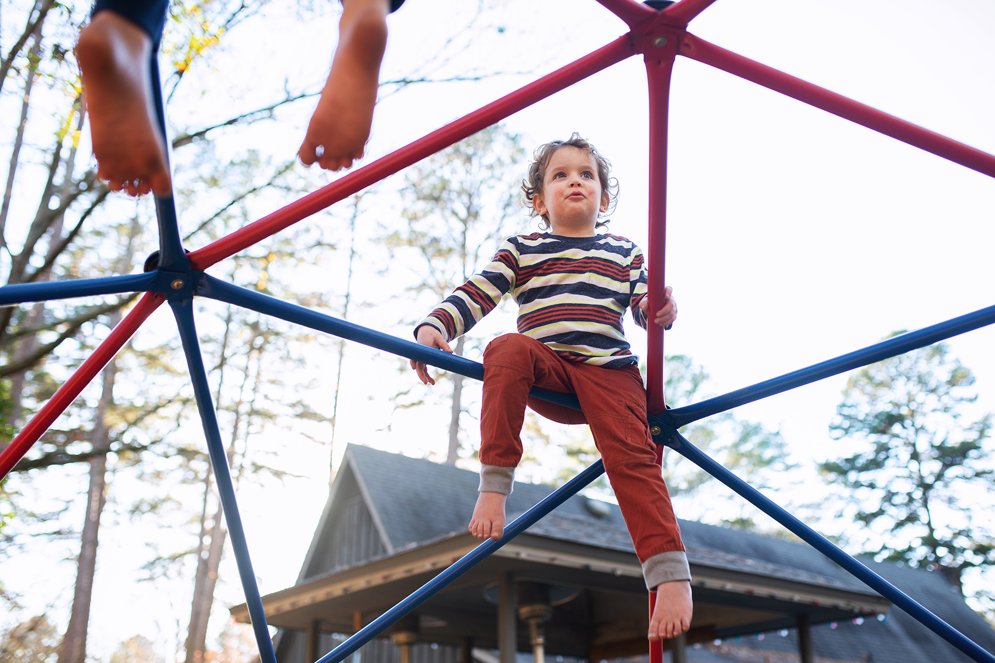 boy on jungle gym - documentary family photography