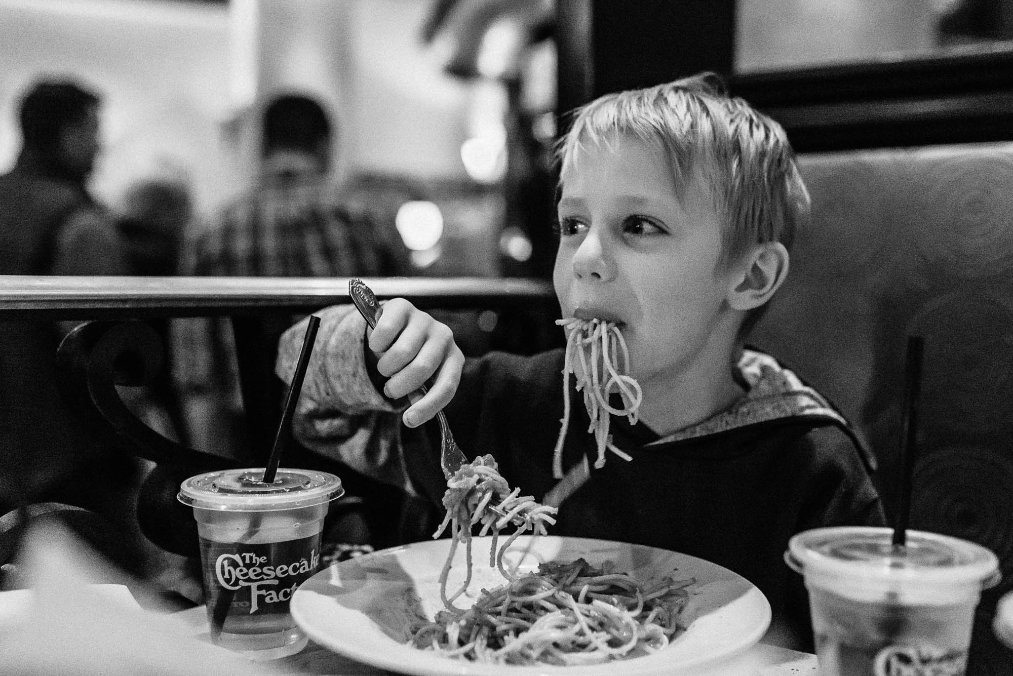boy eating spaghetti - documentary family photography