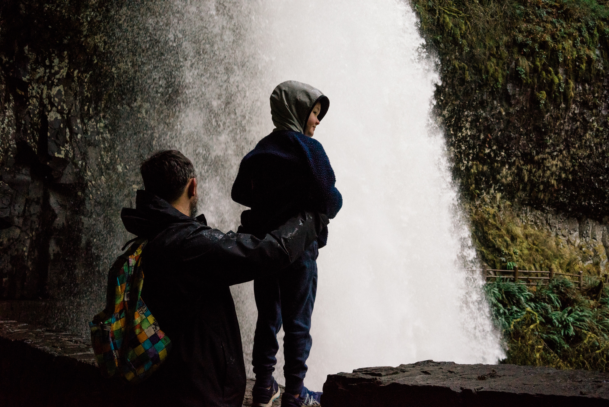 child with father near waterfall - documentary family photography
