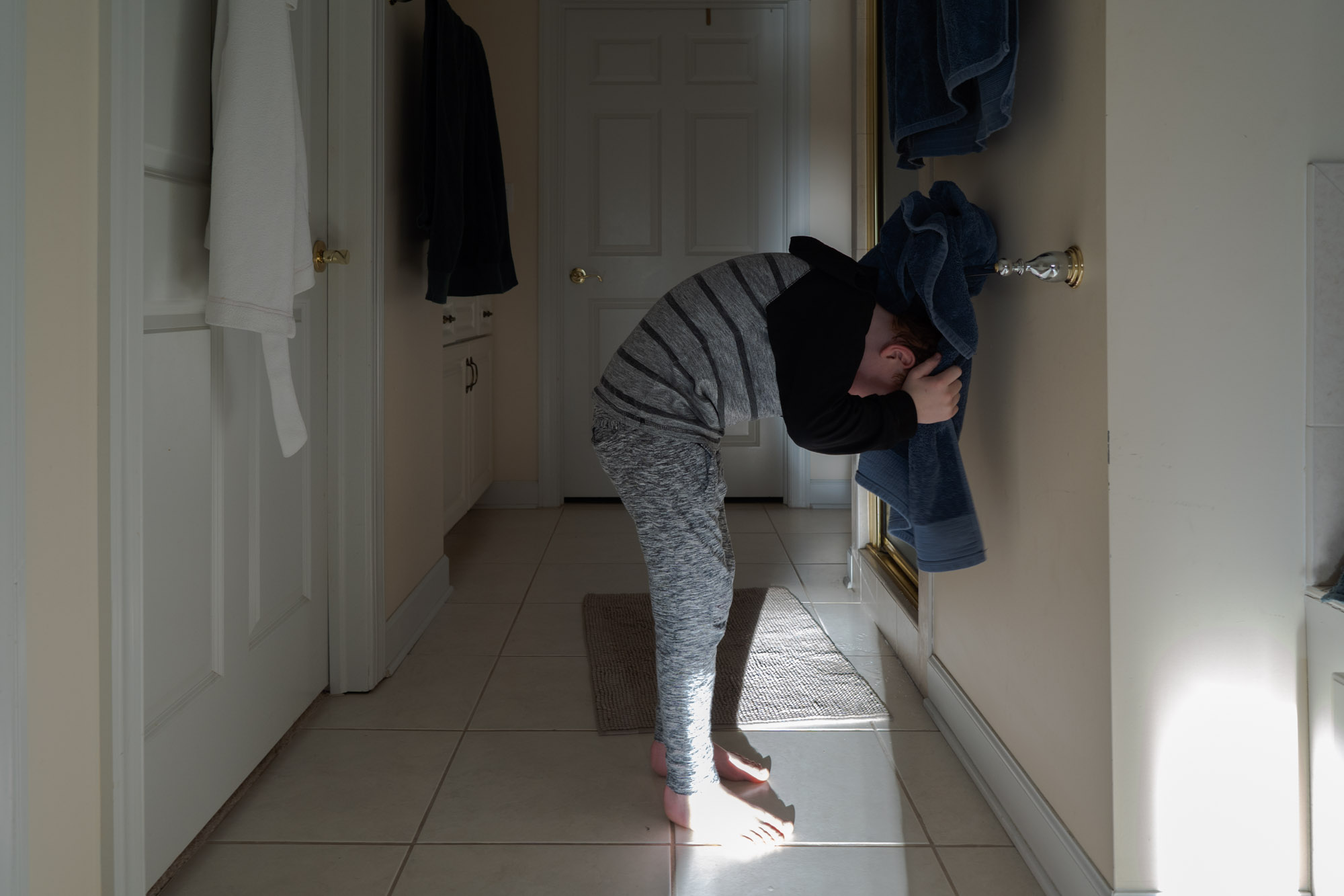 boy leaning on wall - documentary family photography