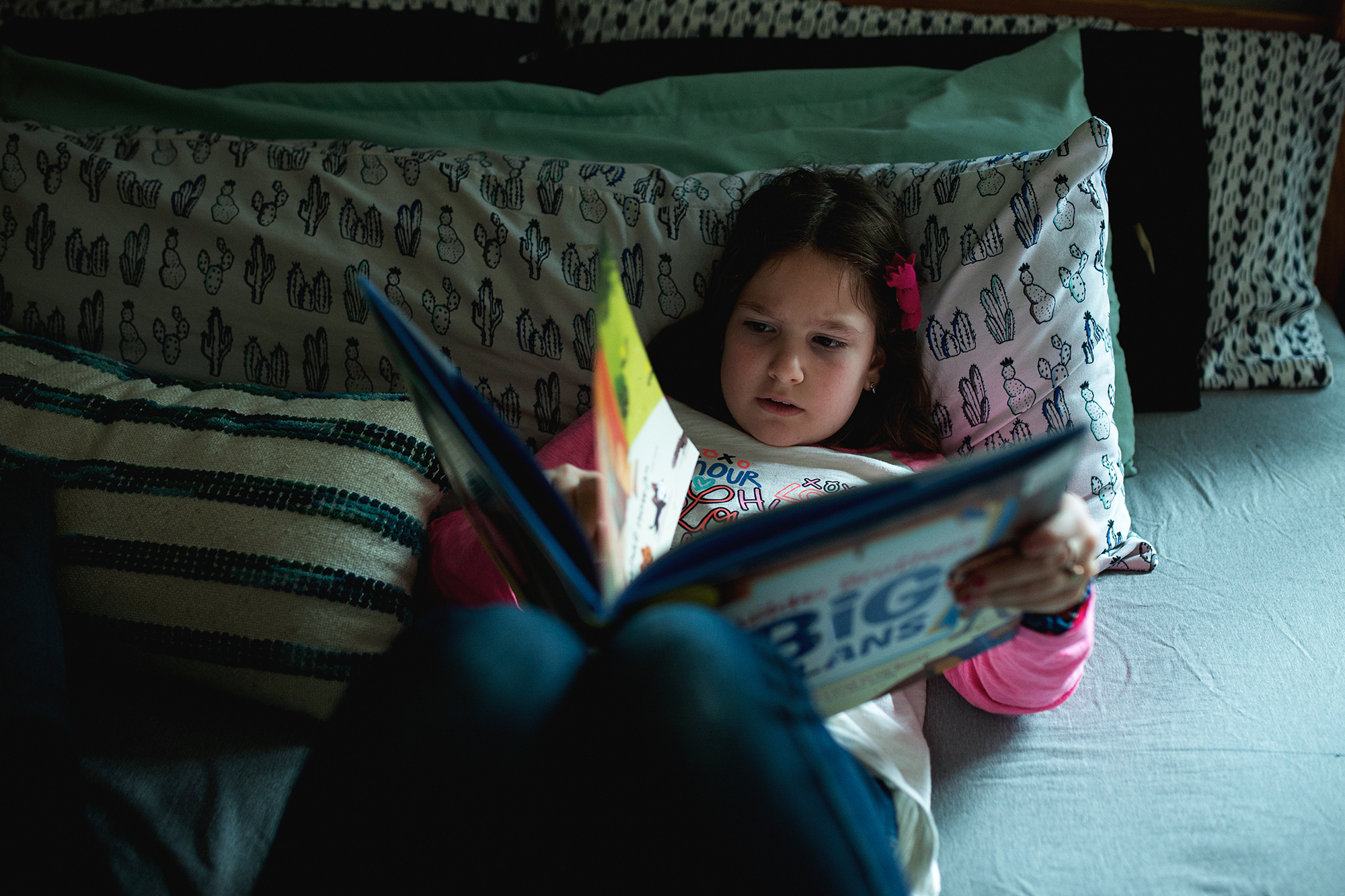 girl reading in bed - documentary family photography