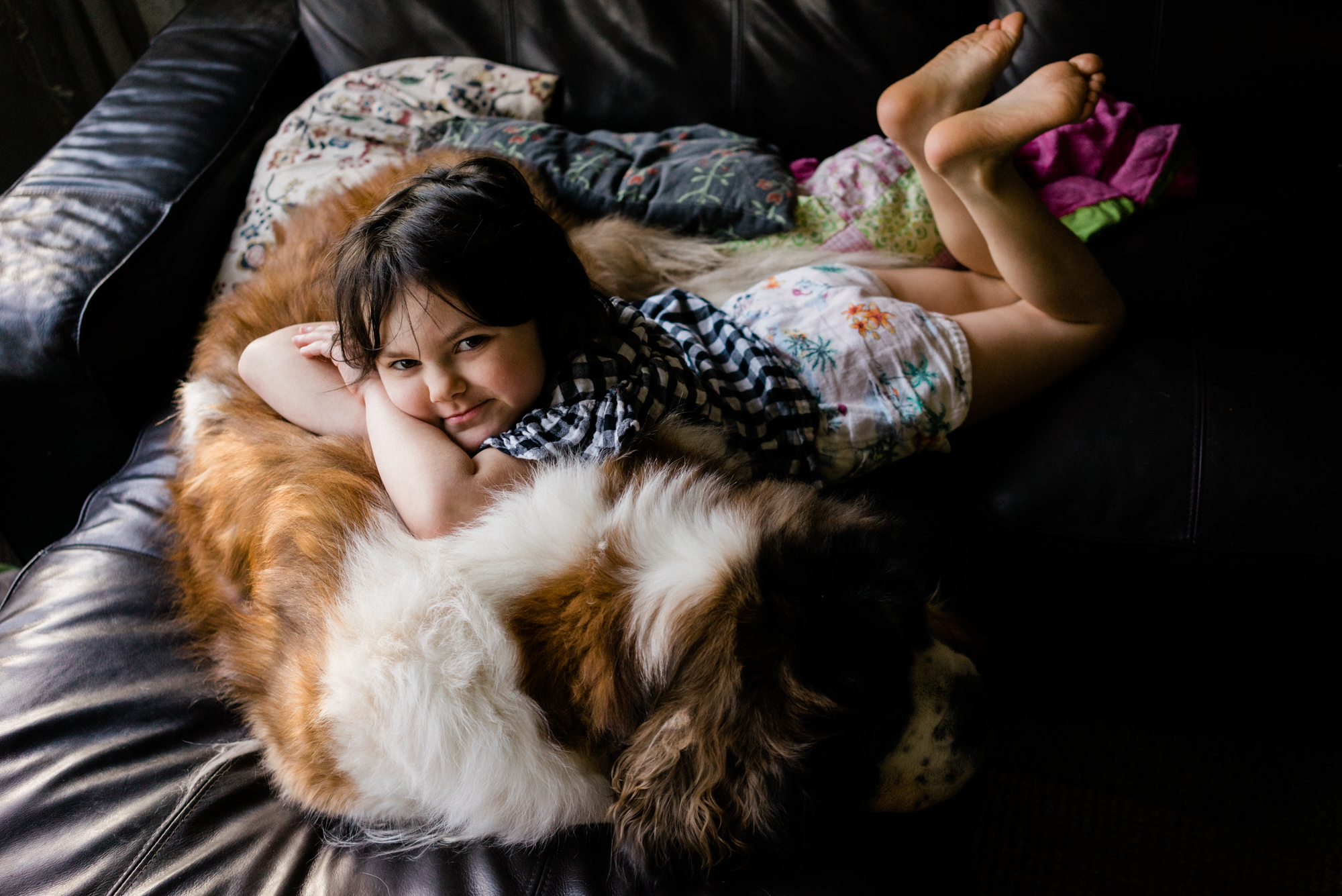 girl cuddling dog - documentary family photography