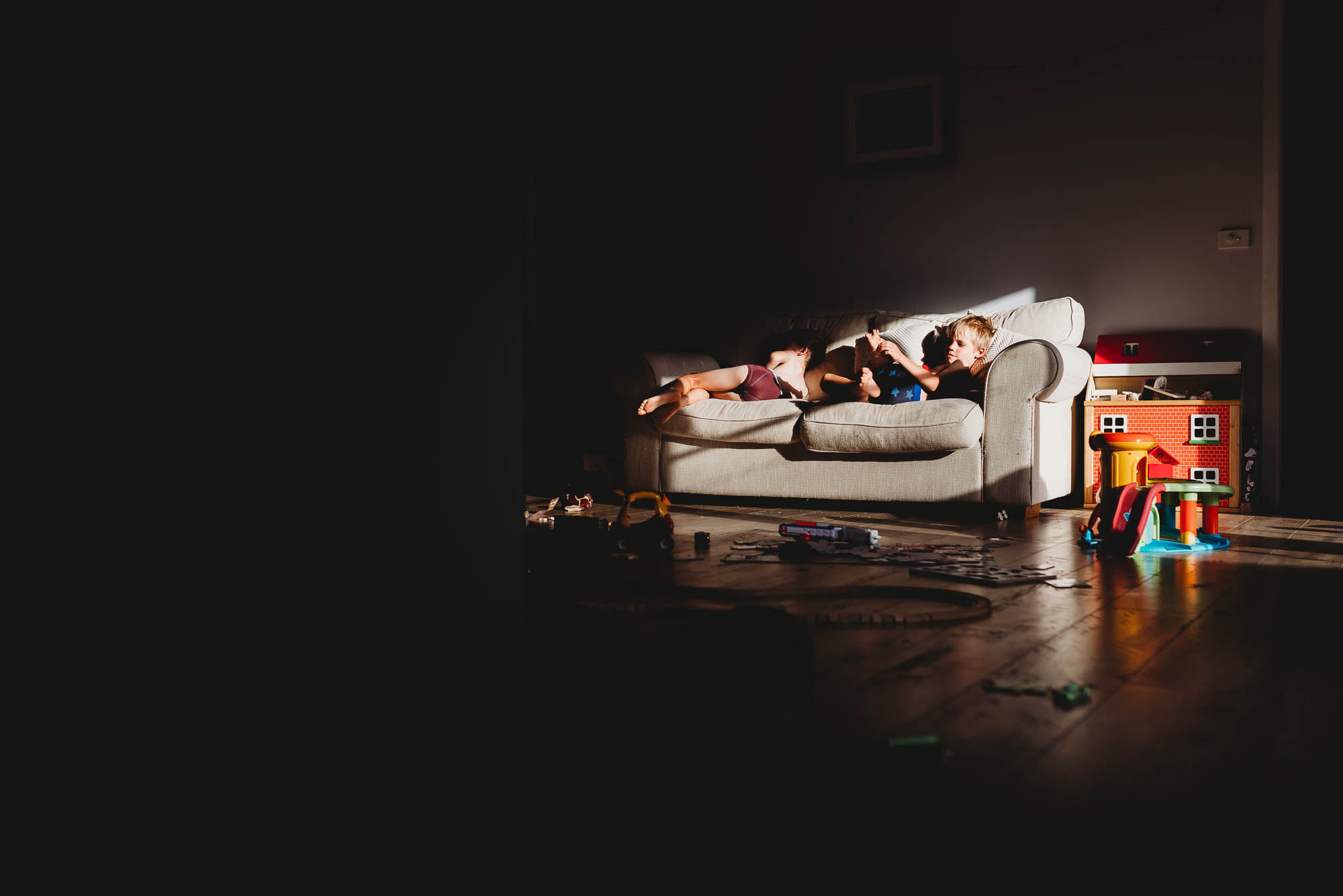 kids on couch in sunlight - documentary family photography