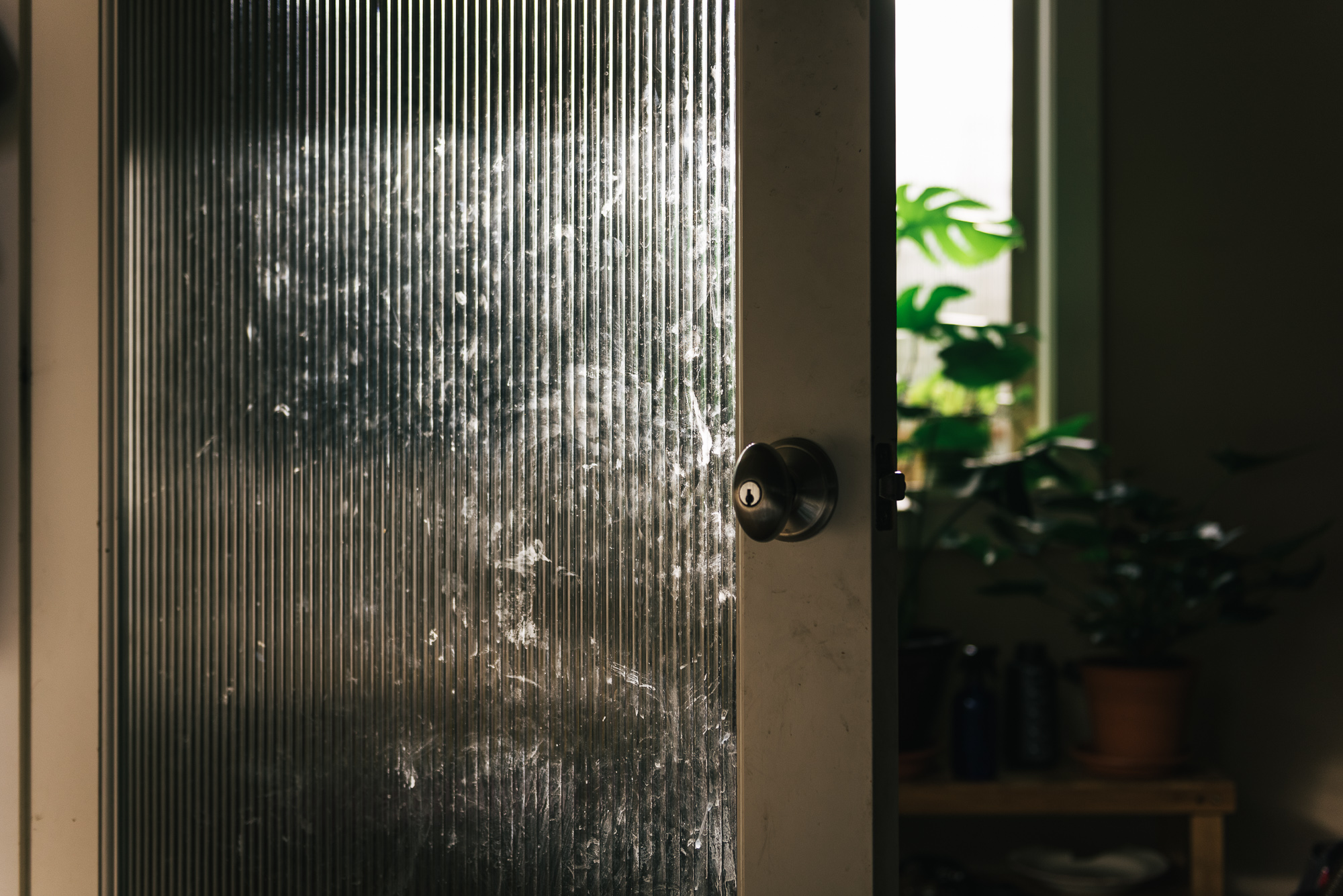 light on door with glass pane - documentary family photography