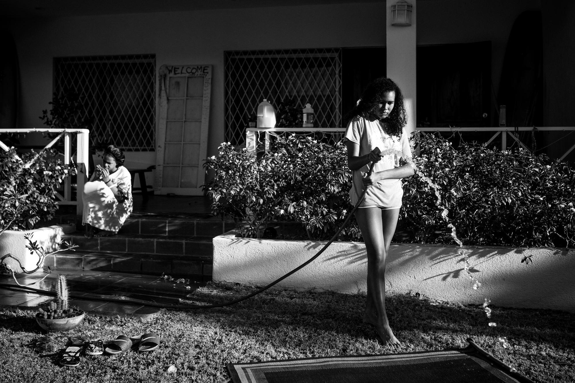 girl watering lawn - documentary family photography