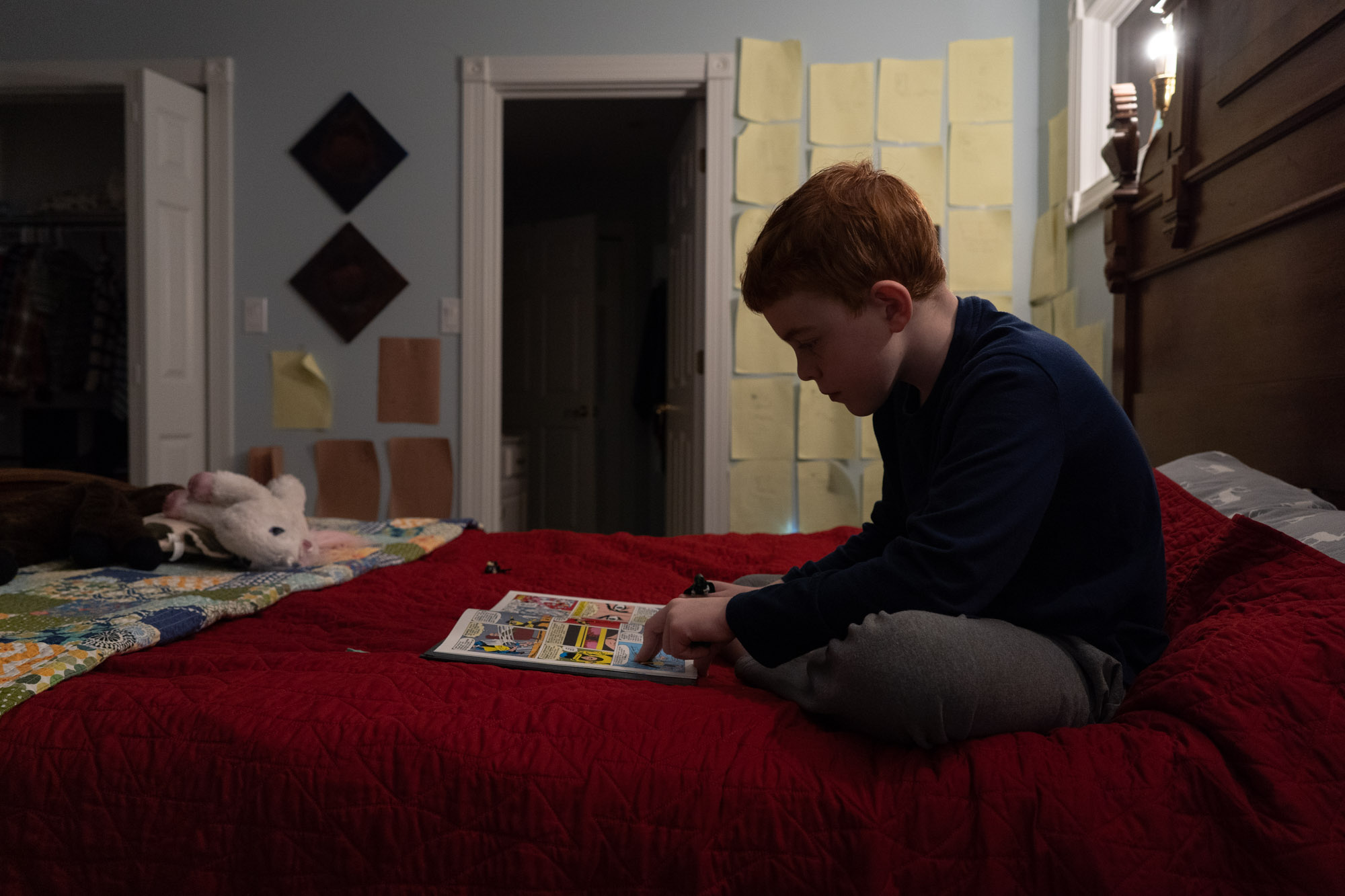 boy reading on bed - documentary family photography